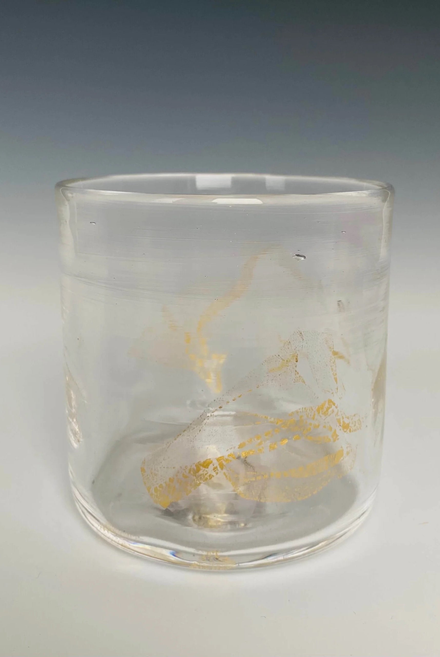 Image of a clear glass with 18k gold hand blown rocks glass made in USA by North Carolina glass artist John Shoemaker
