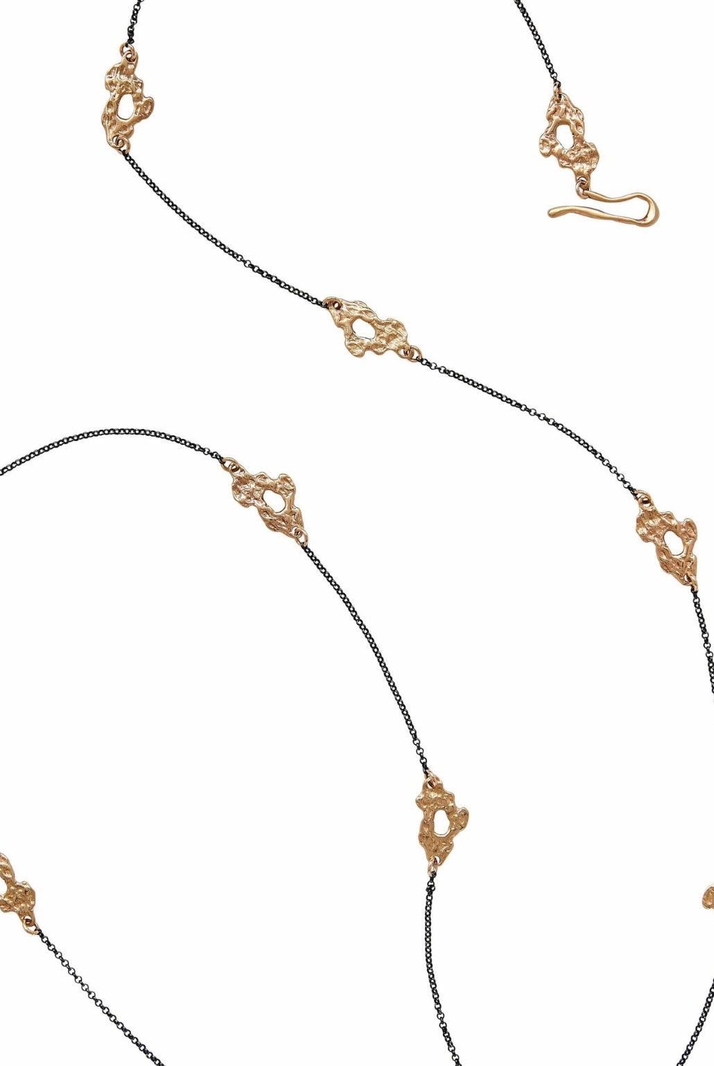 A long oxidized sterling silver chain necklace featuring a series of small bronze cast reef links handmade in USA by Texas artist Julie Cohn