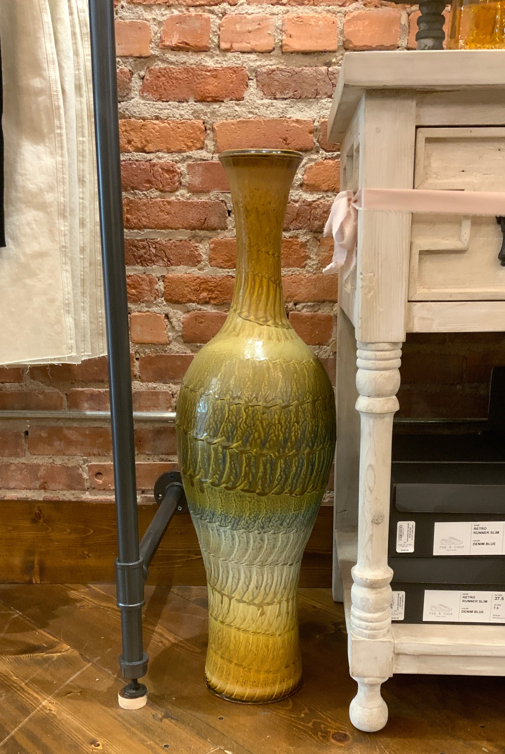 Image featuring North Carolina artist Joey Sheehan wood fired pottery tall vase sculpture.