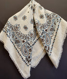 Image of luxury cashmere brand Kujten bandana printed scarf in birch with blue and brown colorway