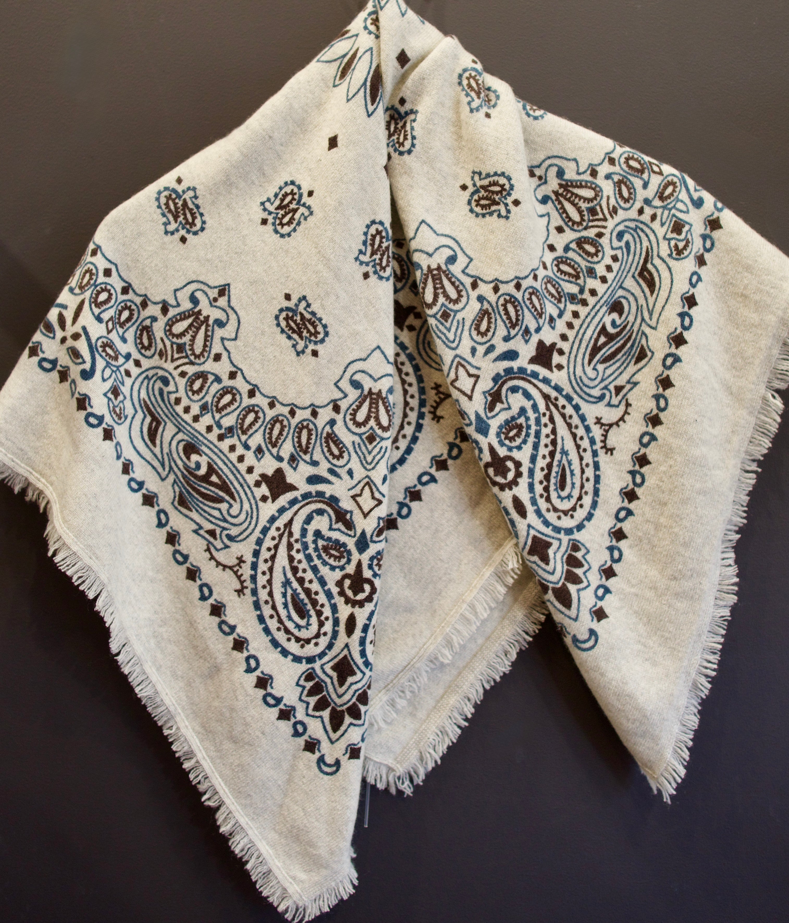 Image of luxury cashmere brand Kujten bandana printed scarf in birch with blue and brown colorway