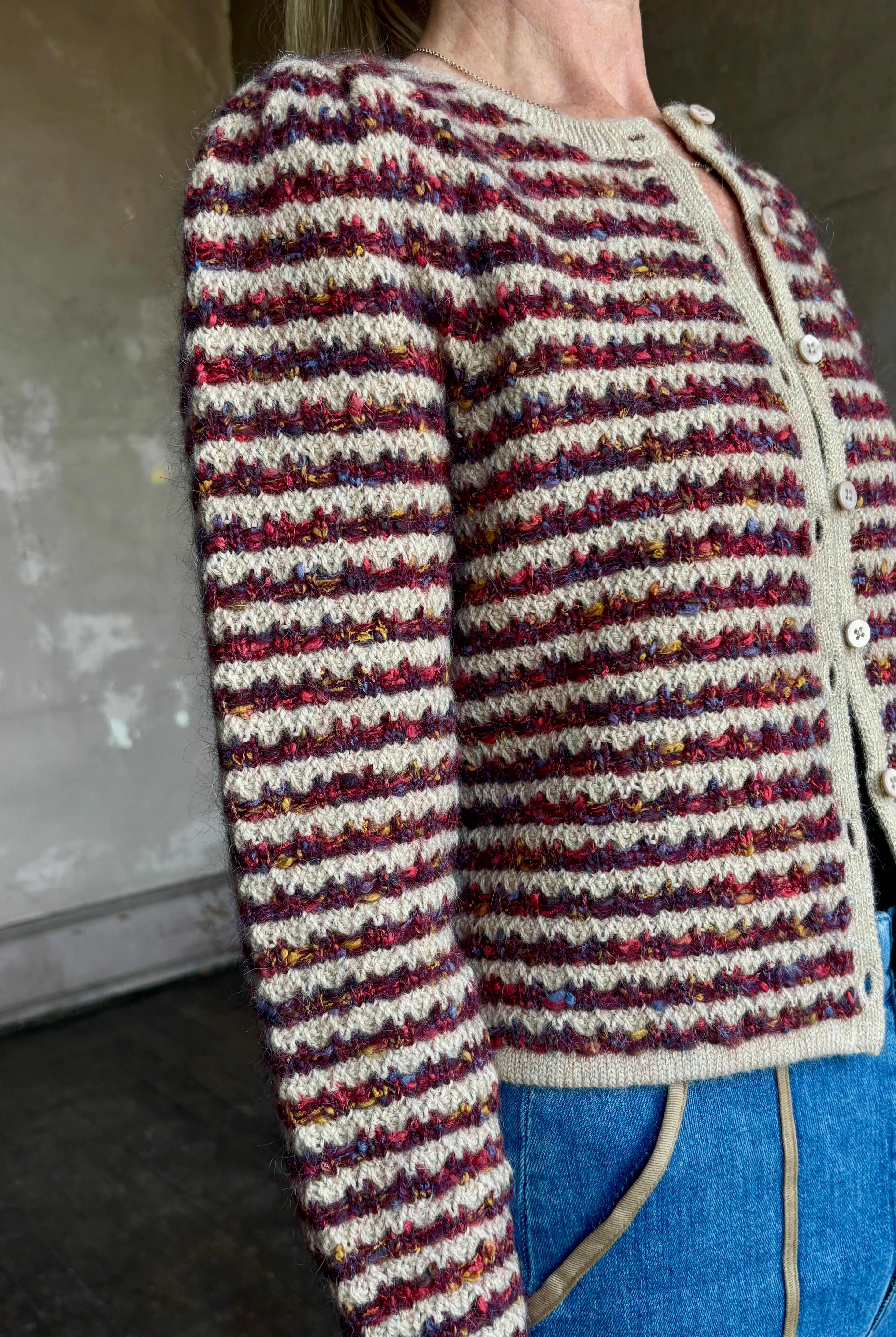 Image of woman wearing an elevated basic Le Jean Jasmine button up long sleeve alpaca blend cardigan sweater with burgundy and khaki stripe