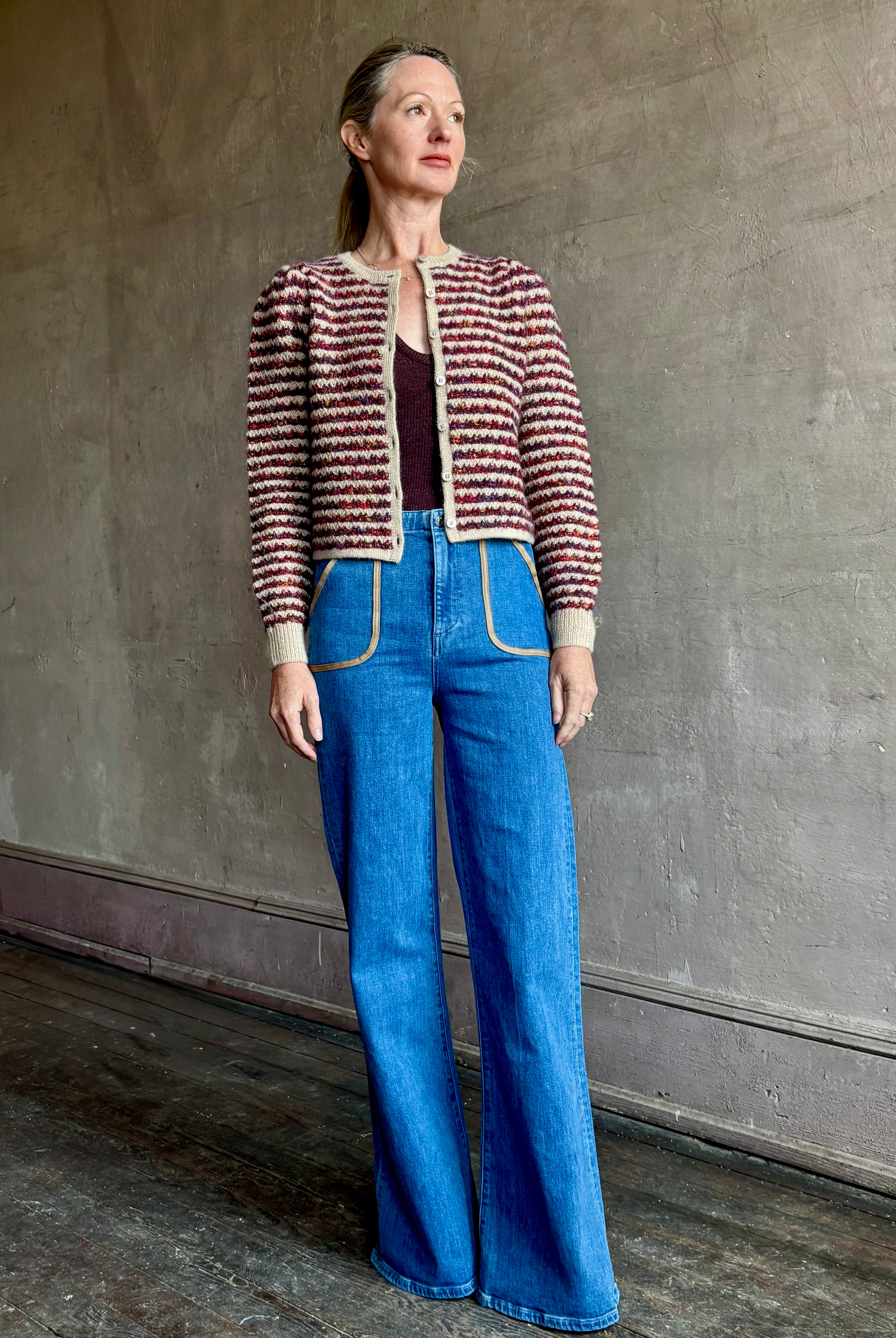 Image of a woman wearing Le Jean Joni flare high rise denim with outlined front pockets in contrasting fabric with a classic retro flare