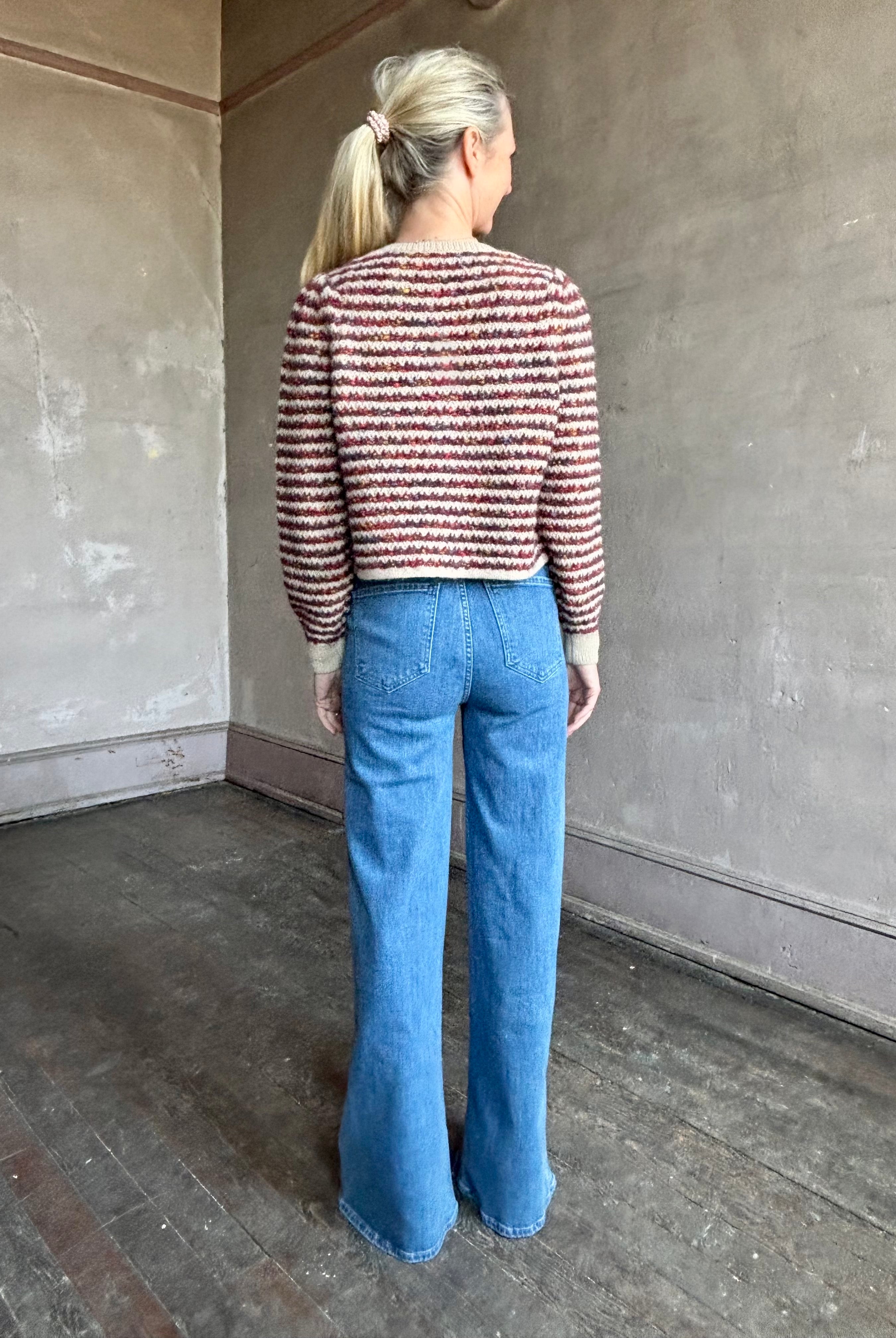 Image of a woman wearing Le Jean Joni flare high rise denim with outlined front pockets in contrasting fabric with a classic retro flare