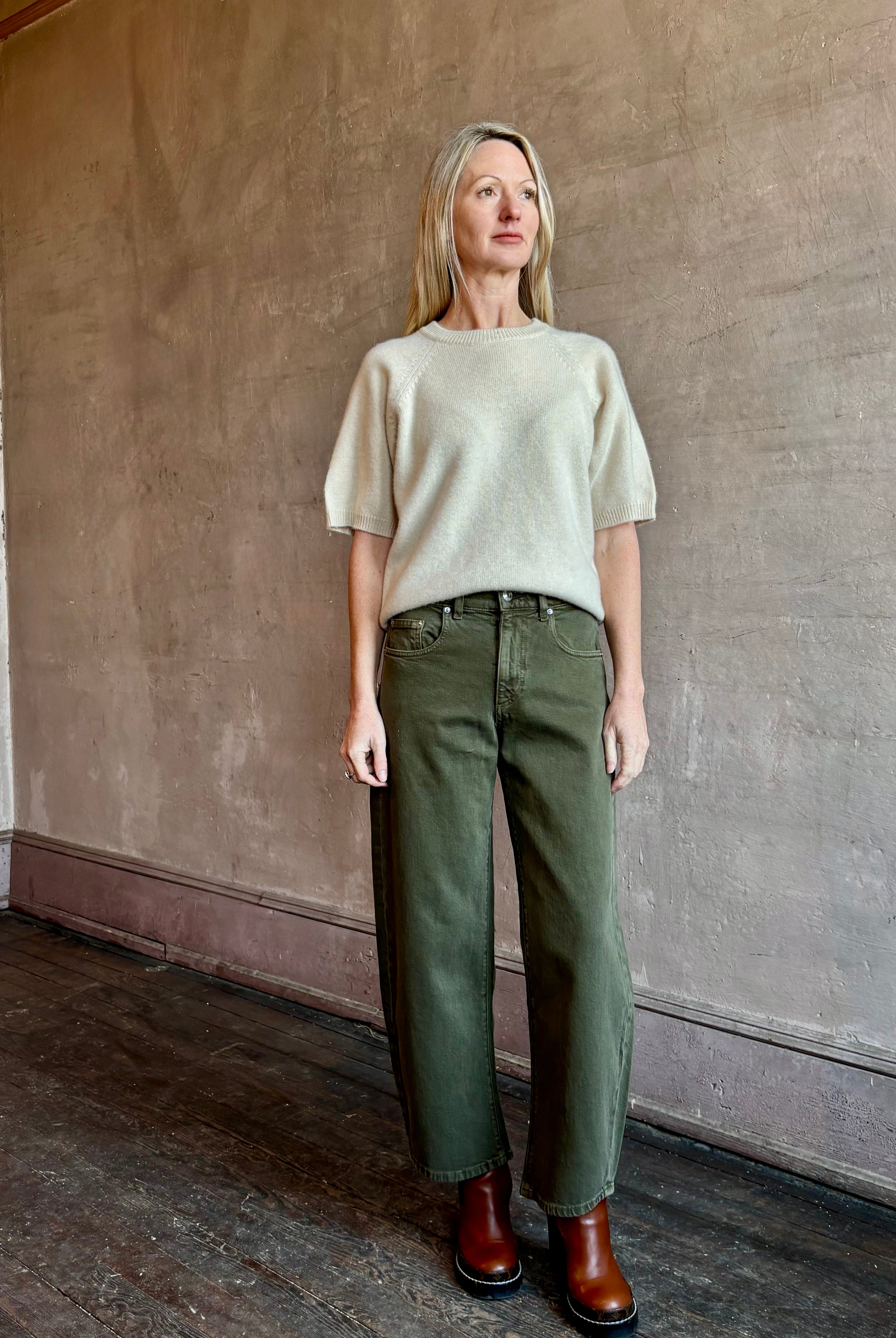 Image of mature woman wearing American Made Le Jean Nomad barrel denim in green color