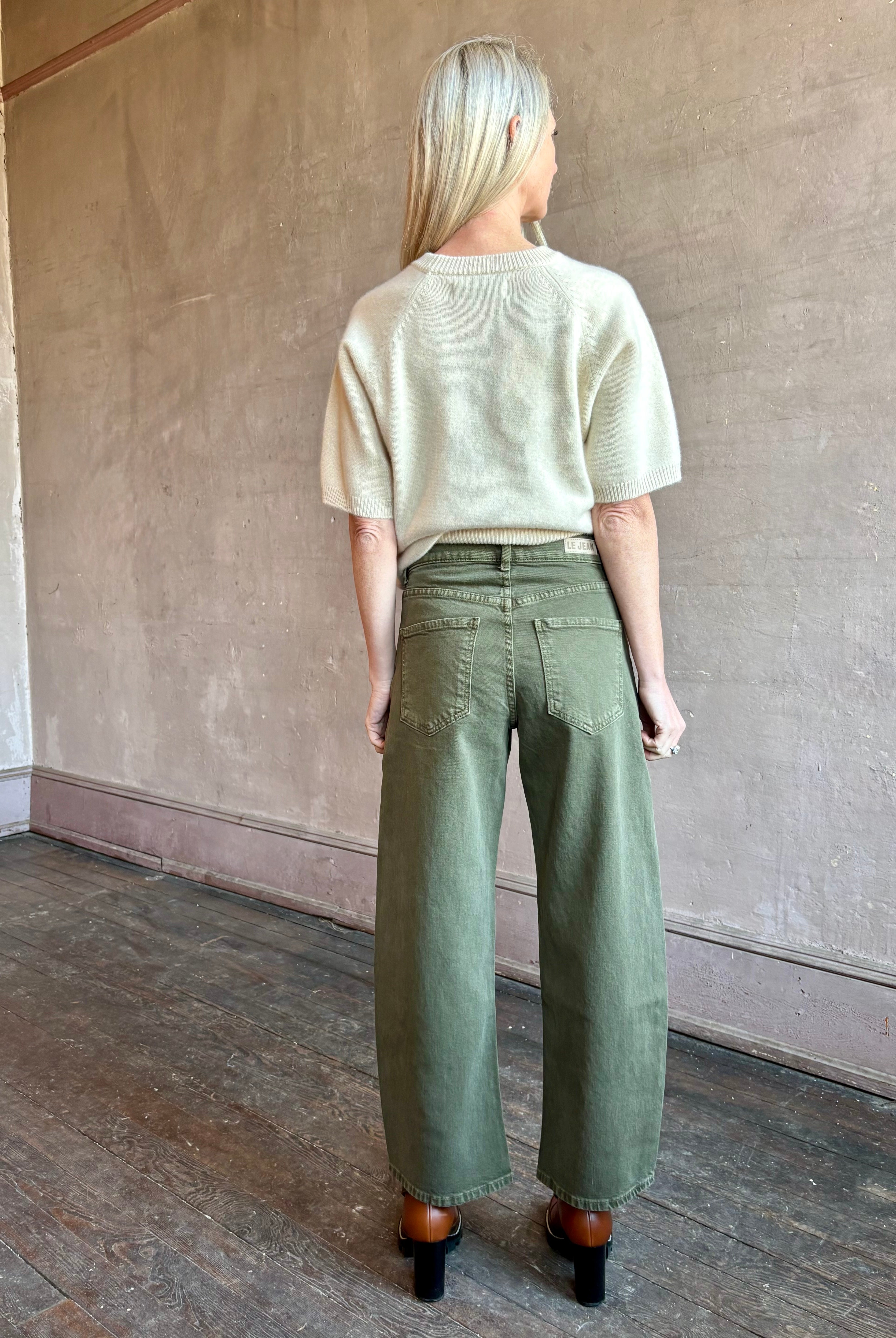 Image of mature woman wearing American made barrel leg cotton denim Le Jean Nomad in green wash