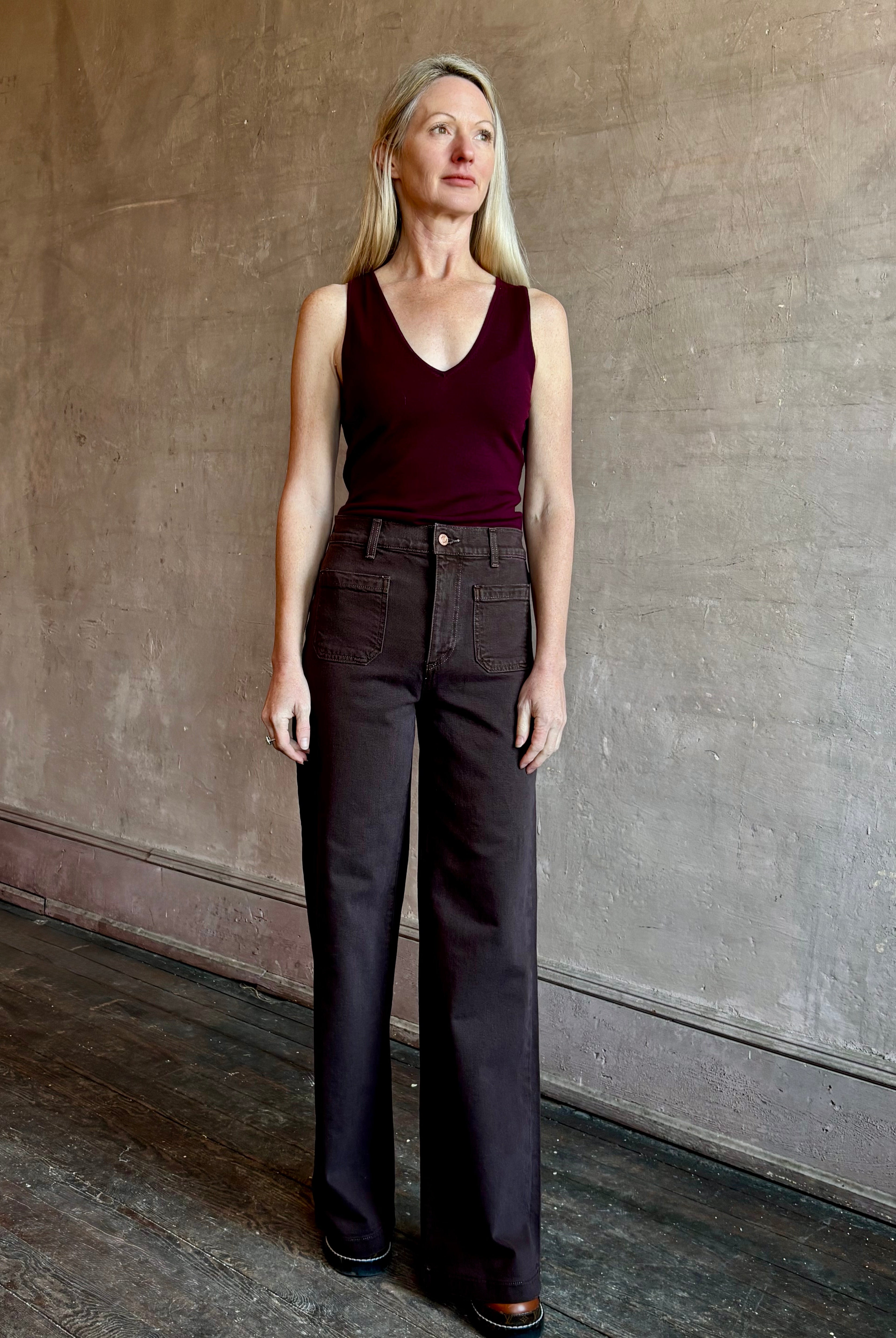 Image of mature woman wearing American made LE JEAN Virginia Wide Leg premium cotton denim in chocolate brown with front patch pockets