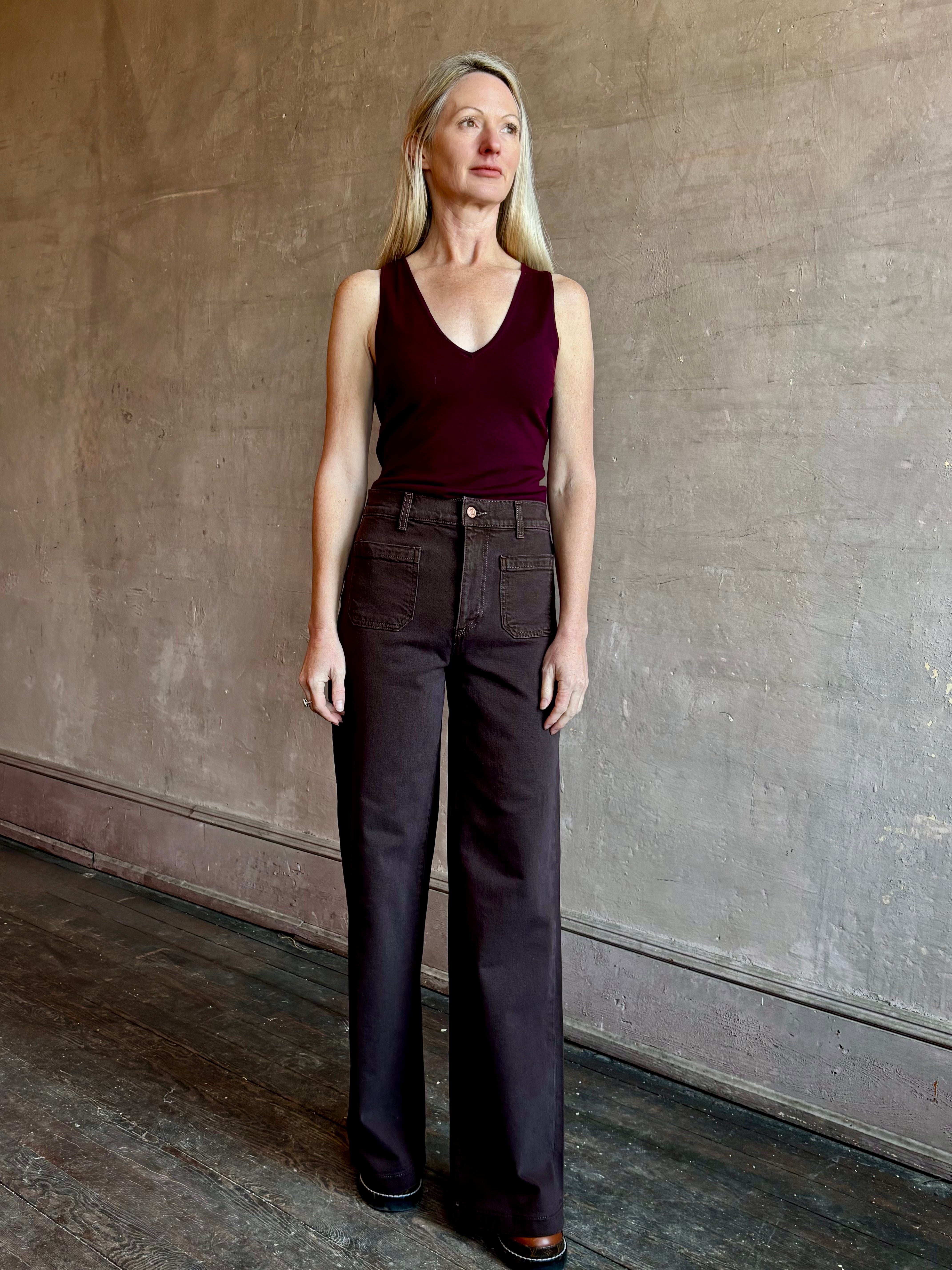 Image of mature woman wearing American made LE JEAN Virginia Wide Leg premium cotton denim in chocolate brown with front patch pockets