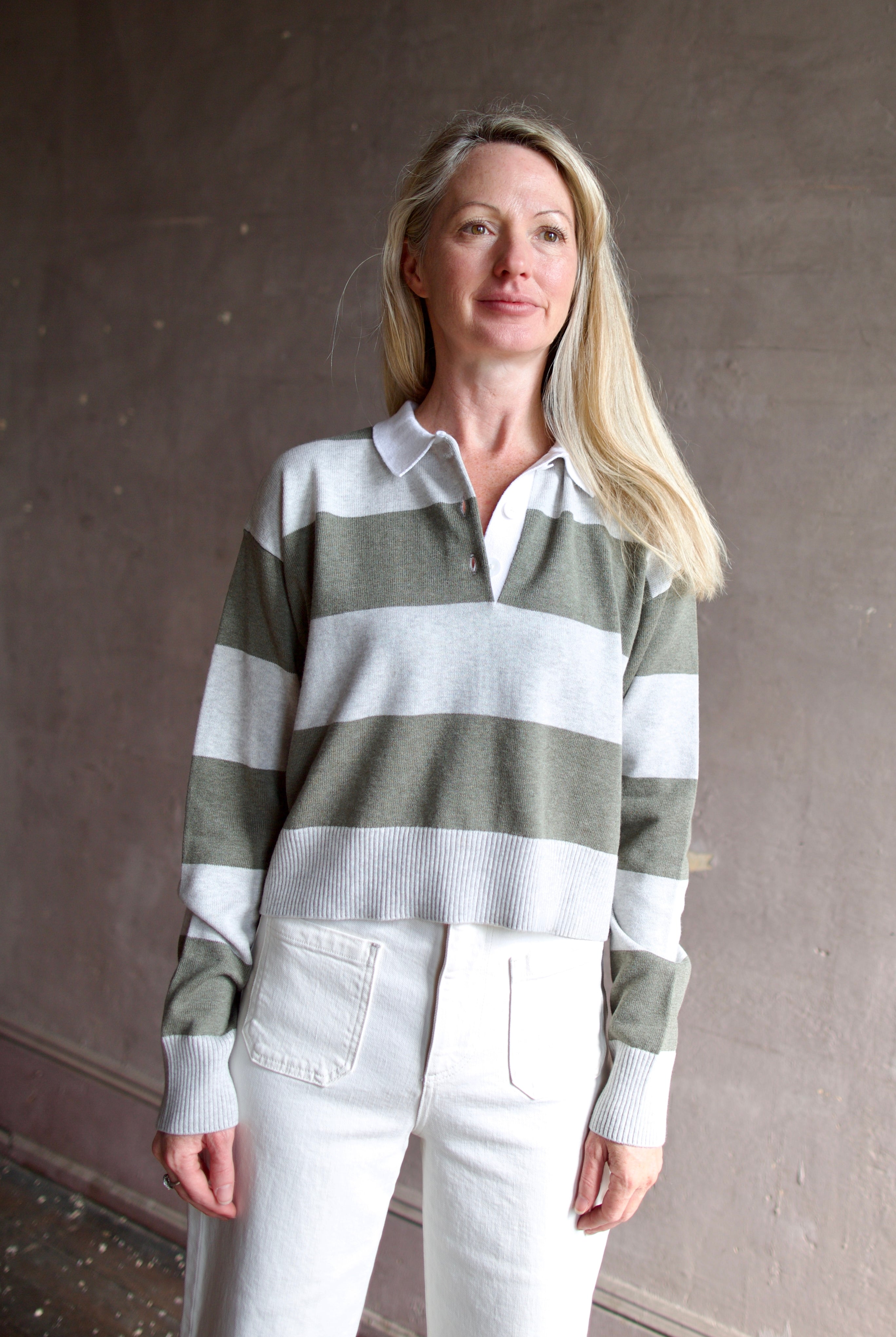 Model wearing Le Jean long sleeve polo in cotton and cashmere.  Elevated casual attire at its finest.