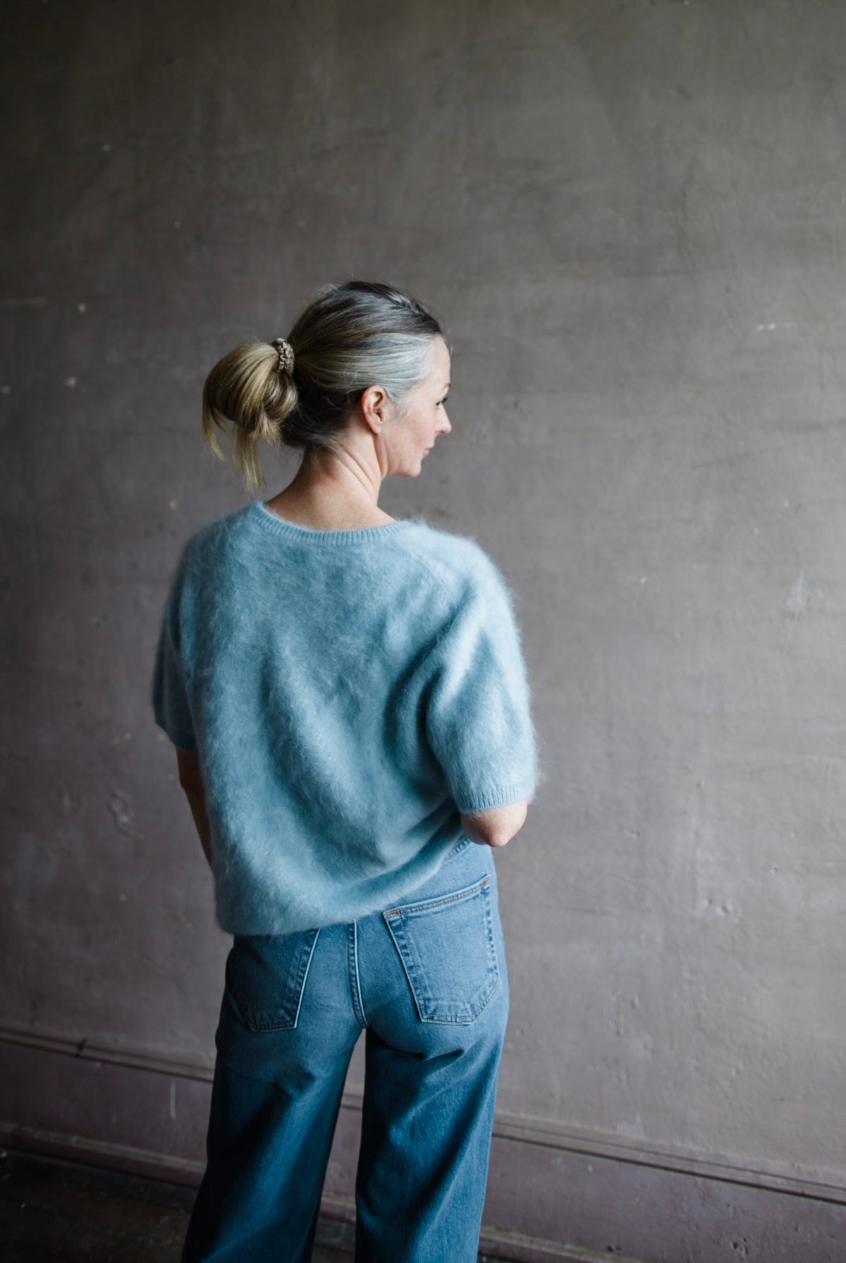 Image featuring a woman wearing the Lovisa sweater by Lisa Yang with a v neckline, short sleeves and in the softest powder blue brushed cashmere.