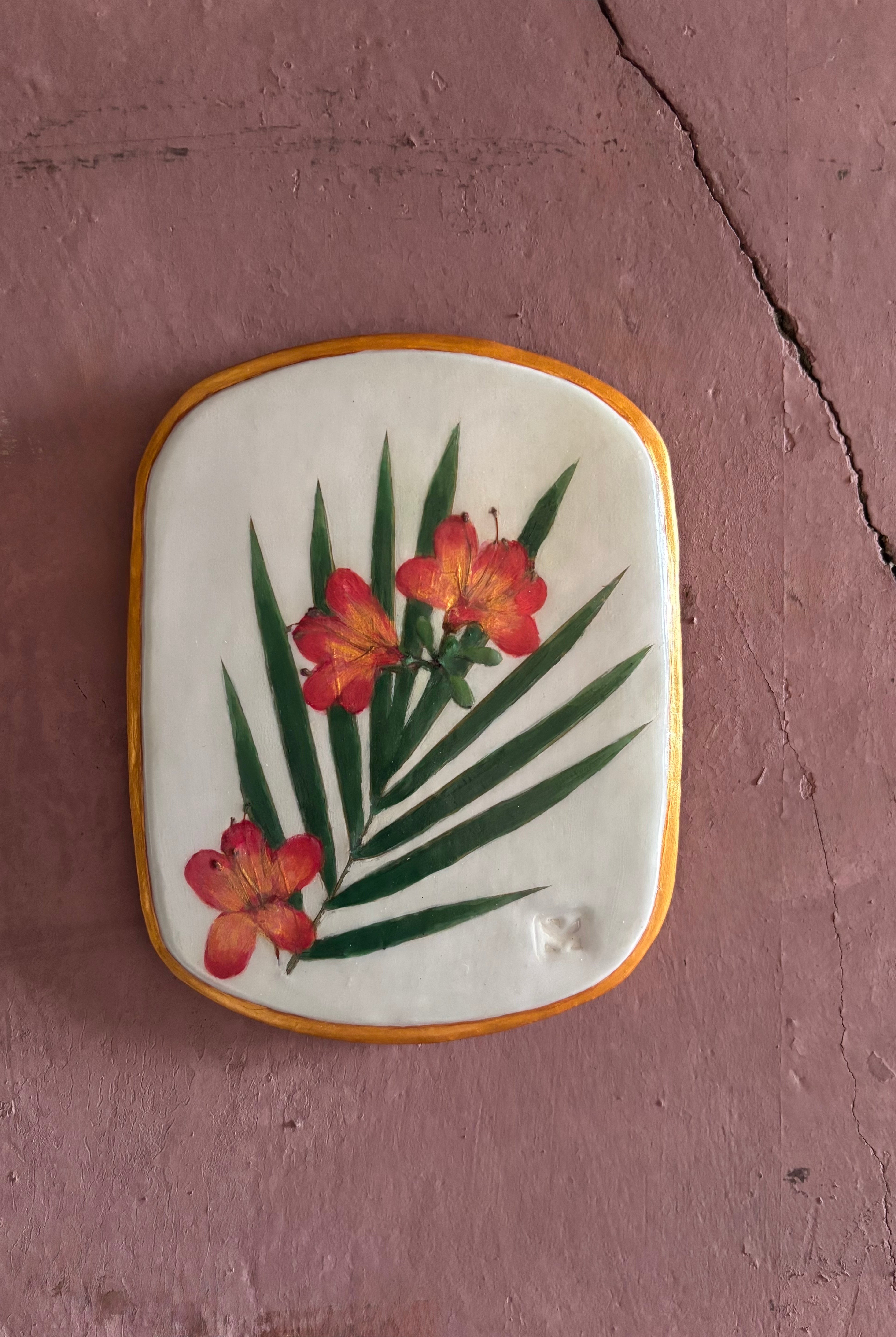 A rectangular ceramic tile featuring botanical pressed azaleas with green palm leaves on white clay