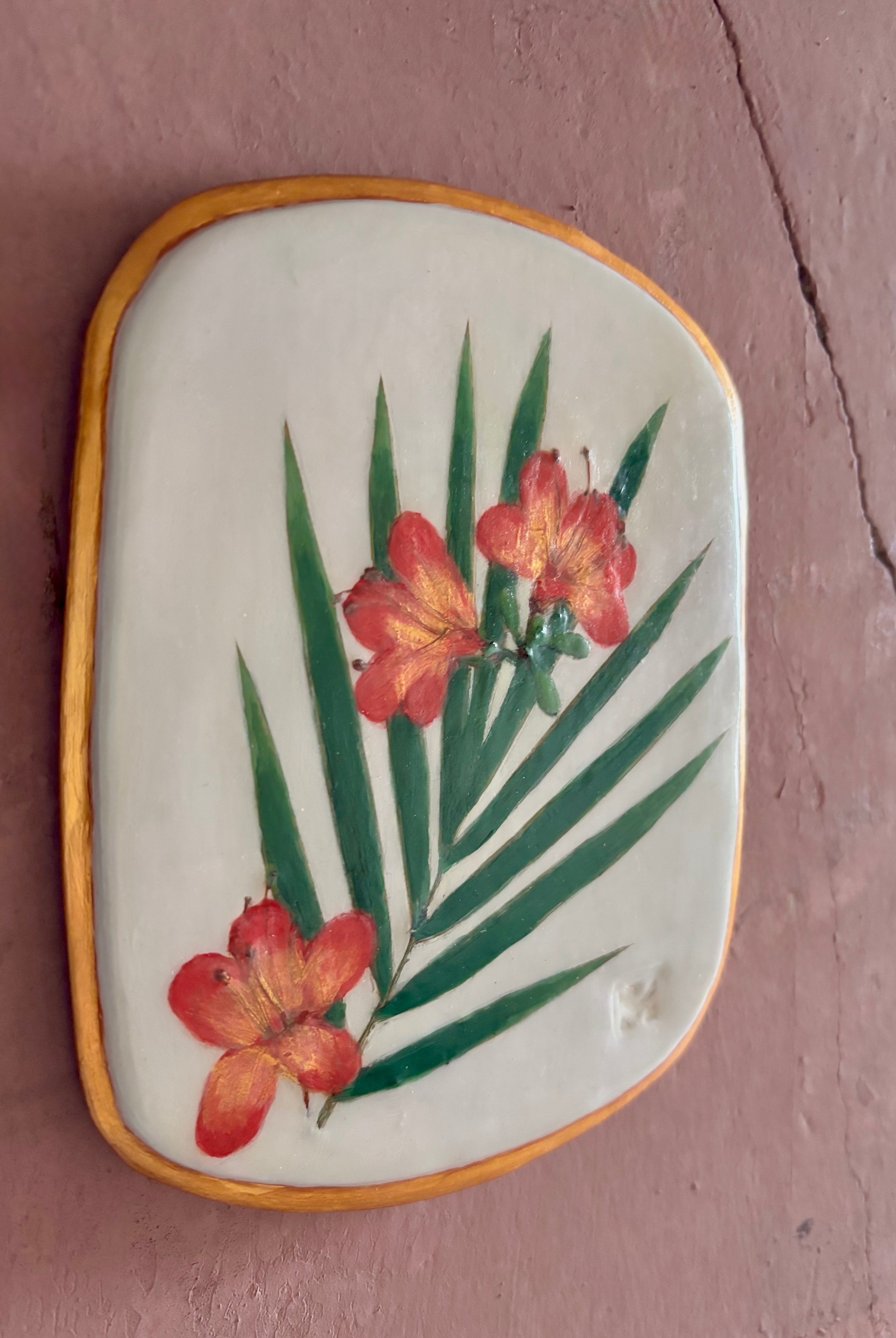A rectangular ceramic tile featuring botanical pressed azaleas with green palm leaves on white clay