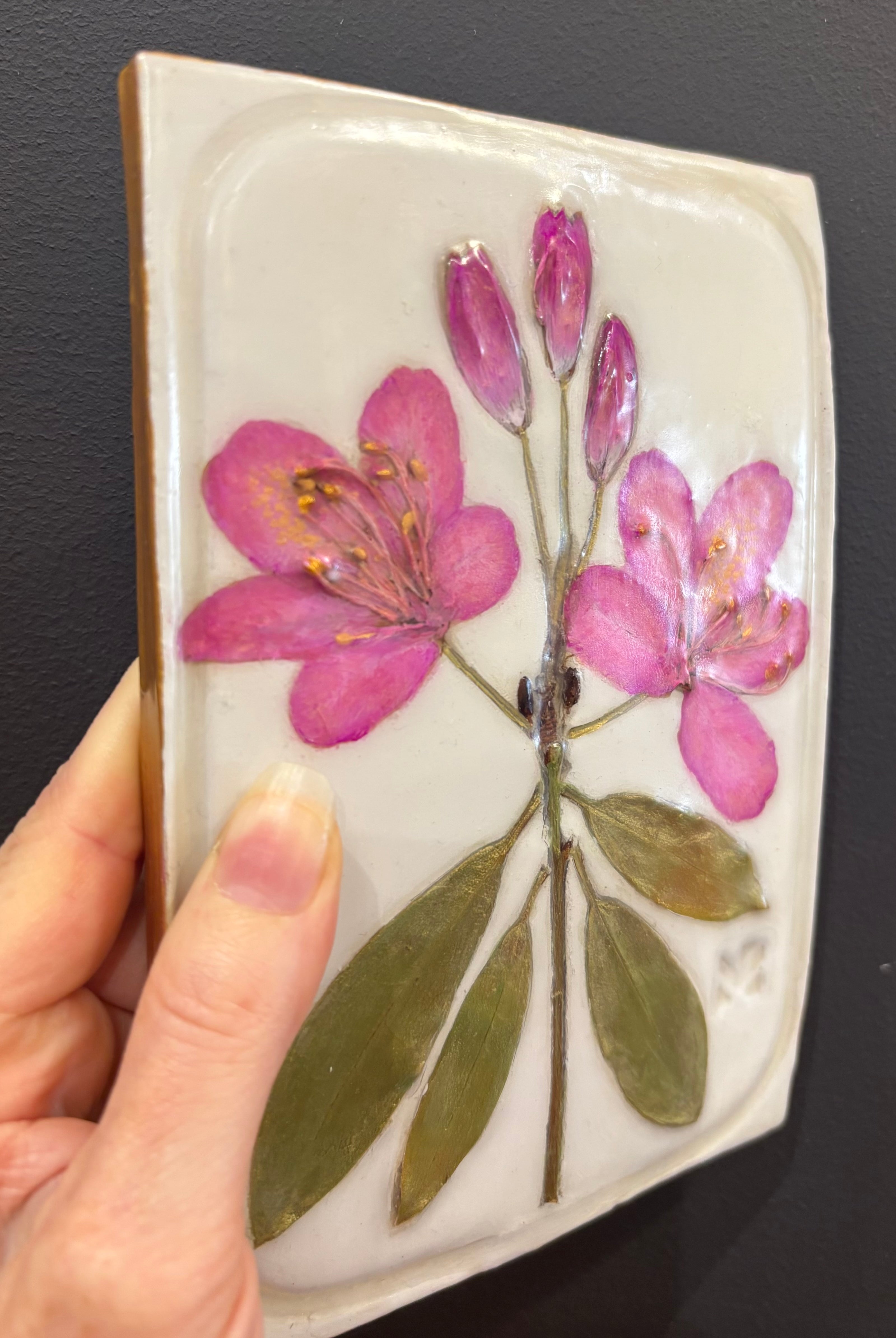 A rectangular ceramic tile with botanical pressed pink rosebay rhododendron on cream clay by local NC artist