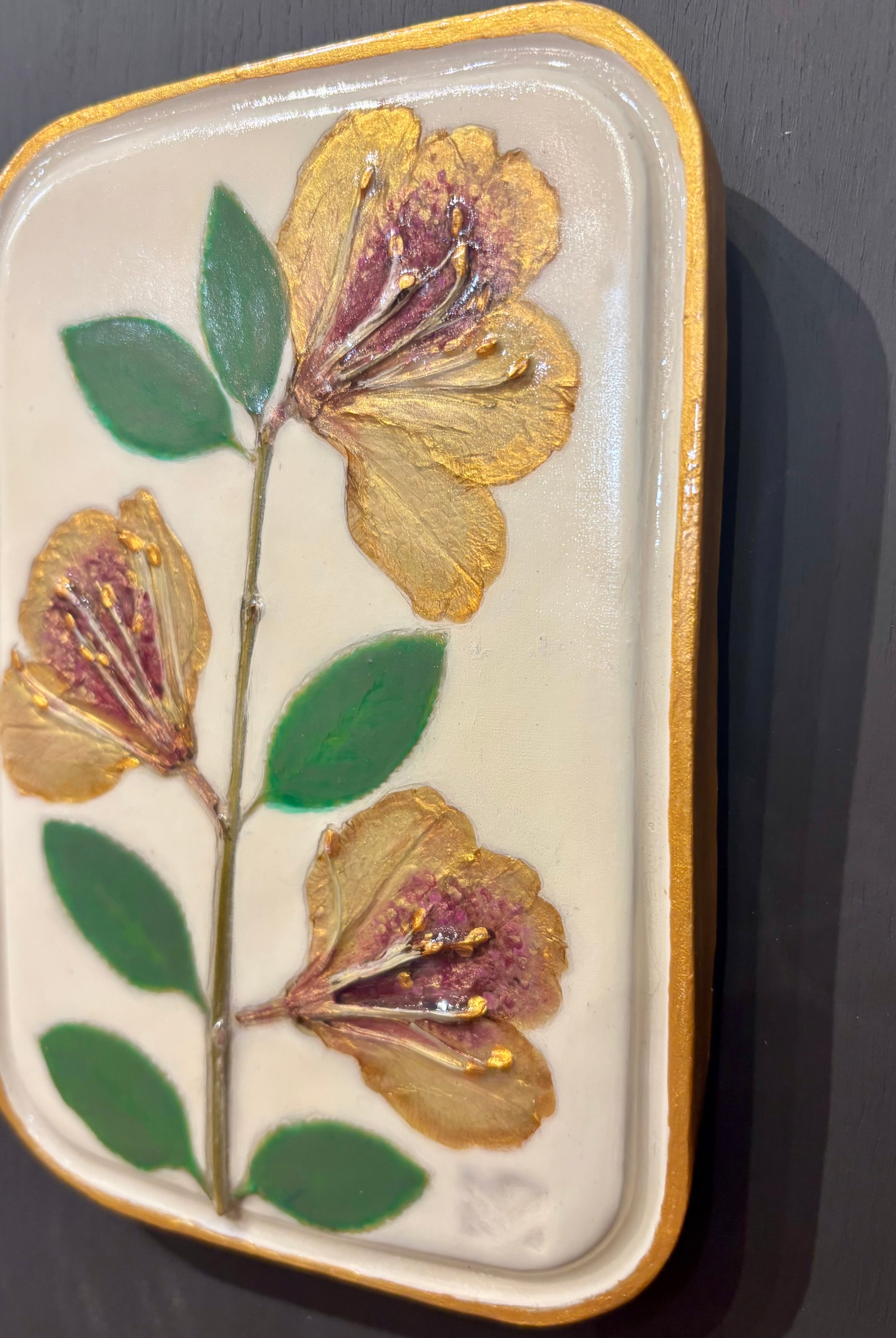 A rectangular ceramic tile with botanical pressed yellow sappora rhododendron on cream clay by local NC artist
