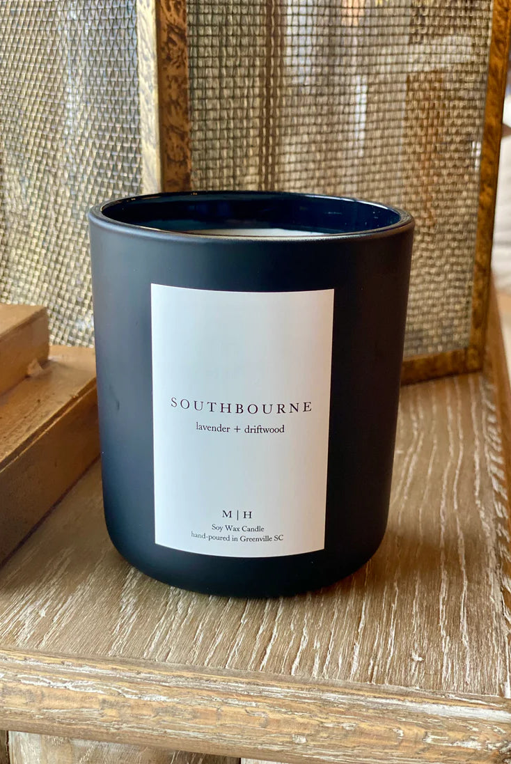 Image of the Southbourne candle hand poured in Greenville South Carolina in a calming blend of lavender and driftwood crafted in a glass container with Soy Wax and a wood wick