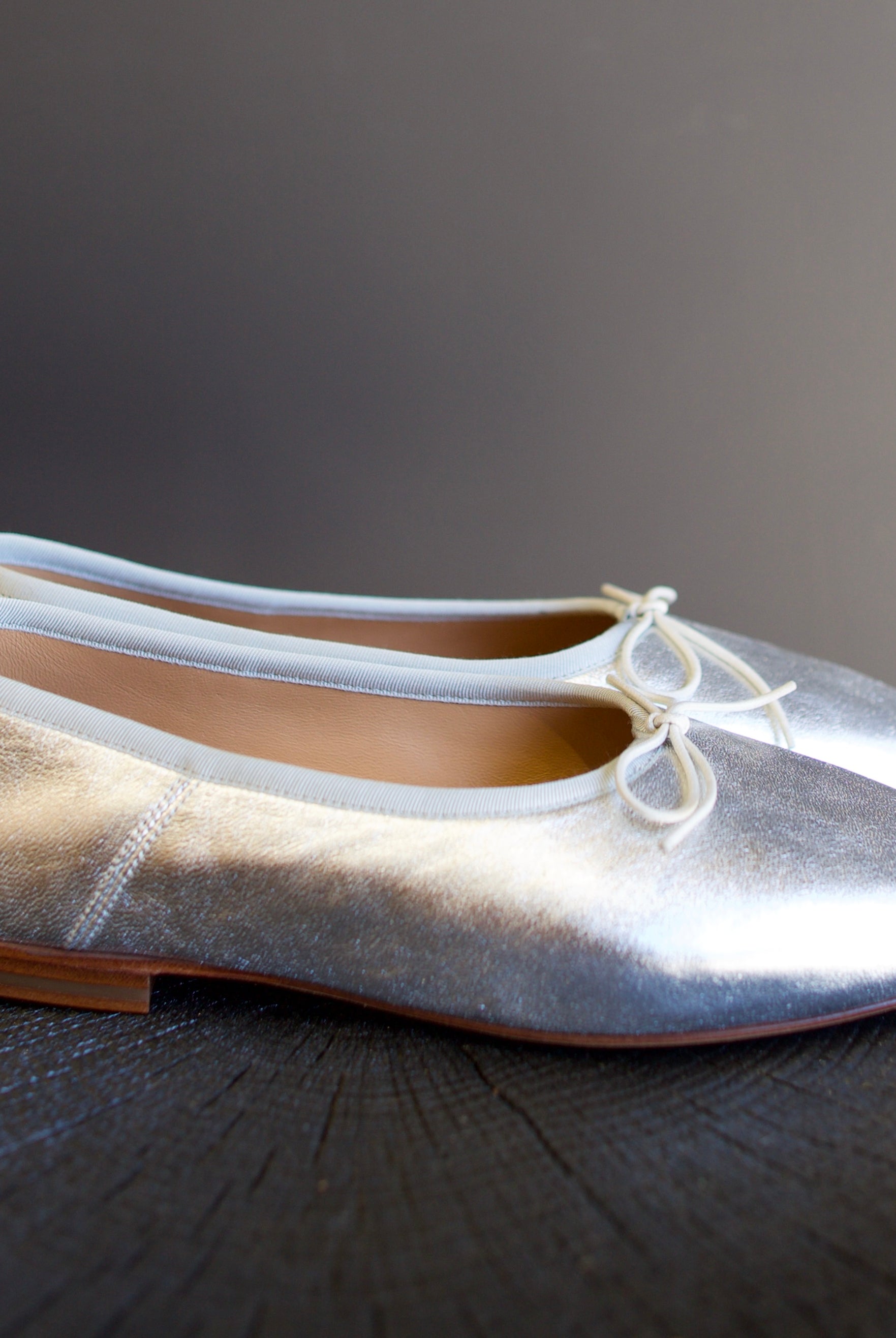 Image featuring the Dream Ballerina Flats by Mansur Gavriel with a small bow with a round toe and flat heel in matte silver.