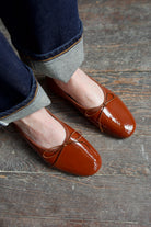 Mansur Gavriel dream ballerina flats in colorway vienna which is a medium   orange toned brown or saddle brown with bows