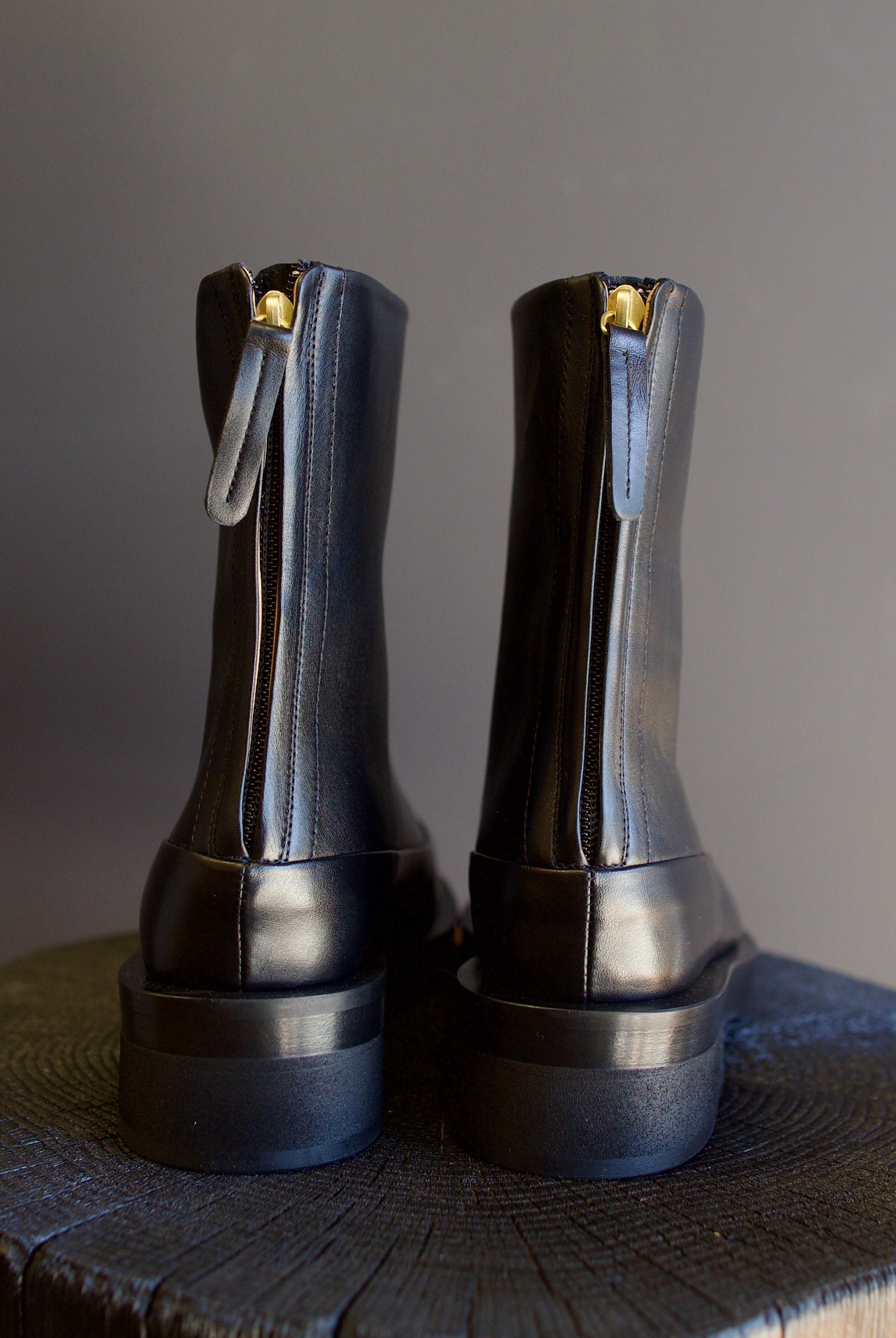 Image featuring The Marion Boot by Mansur Gavriel in black with a round toe, back zip closure and a chunky sole.
