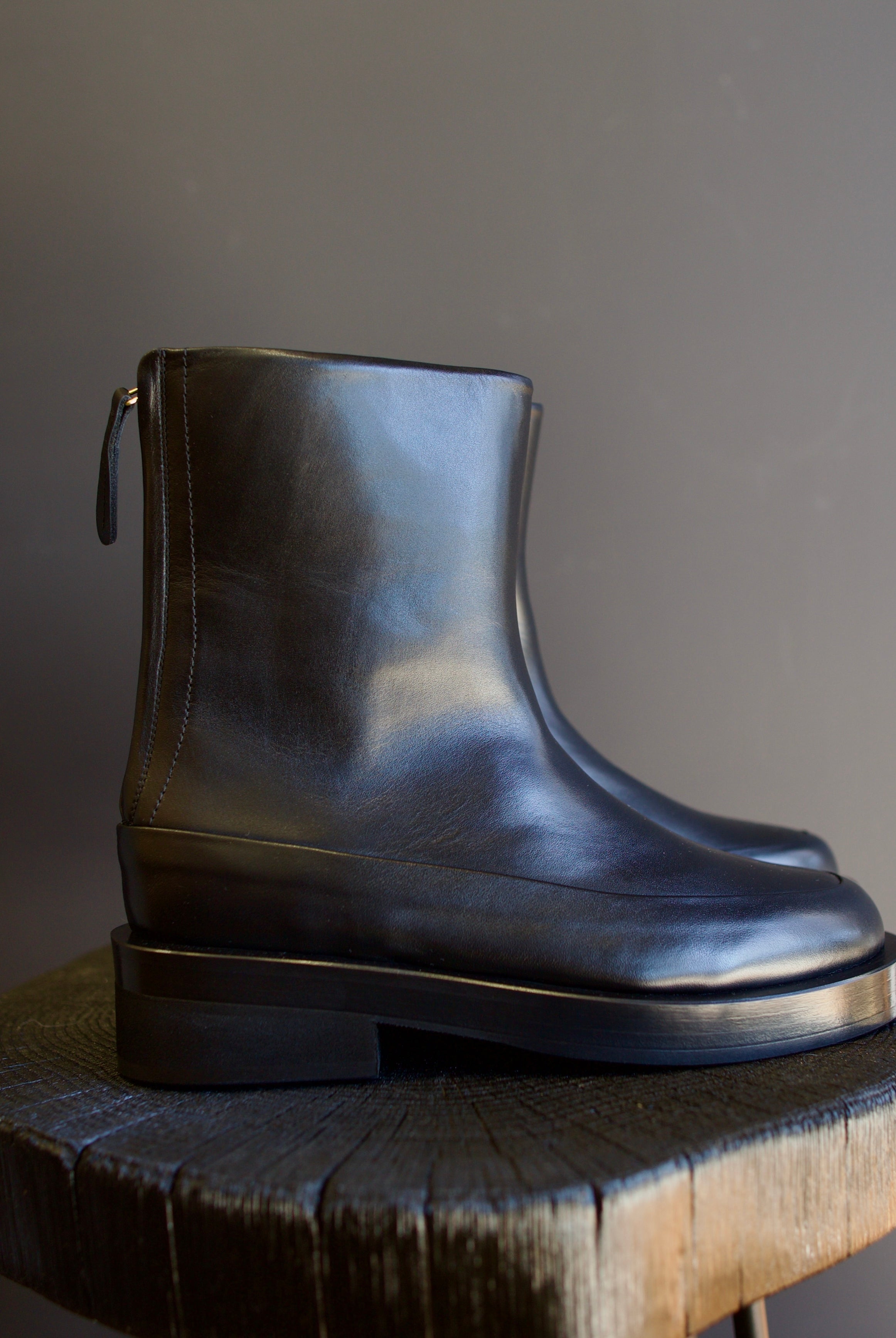 Image featuring The Marion Boot by Mansur Gavriel in black with a round toe, back zip closure and a chunky sole.