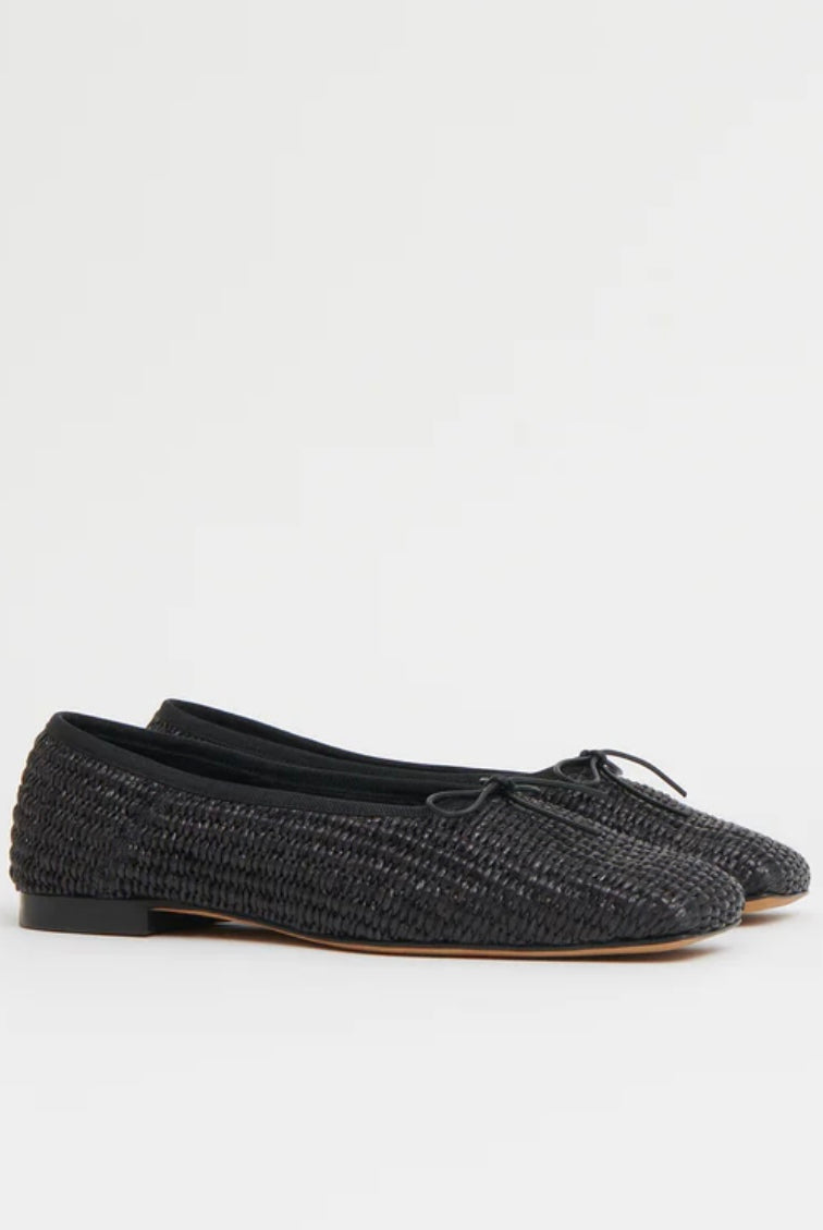 Pair of black woven raffia ballet flats with a square toe and bowtie by high-end footwear designer Mansur
