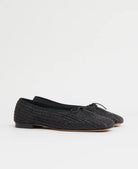 Pair of black woven raffia ballet flats with a square toe and bowtie by high-end footwear designer Mansur