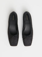 Pair of black woven raffia ballet flats with a square toe and bowtie by high-end footwear designer Mansur Gavriel