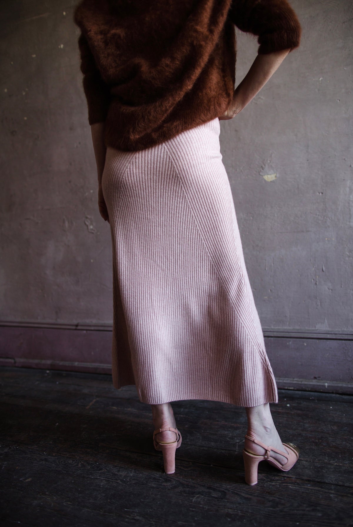 Mature woman wearing Naadam's Ribbed Maxi Wool and Cashmere blend knit Skirt in Blush elastic waistband modern ribbed texture