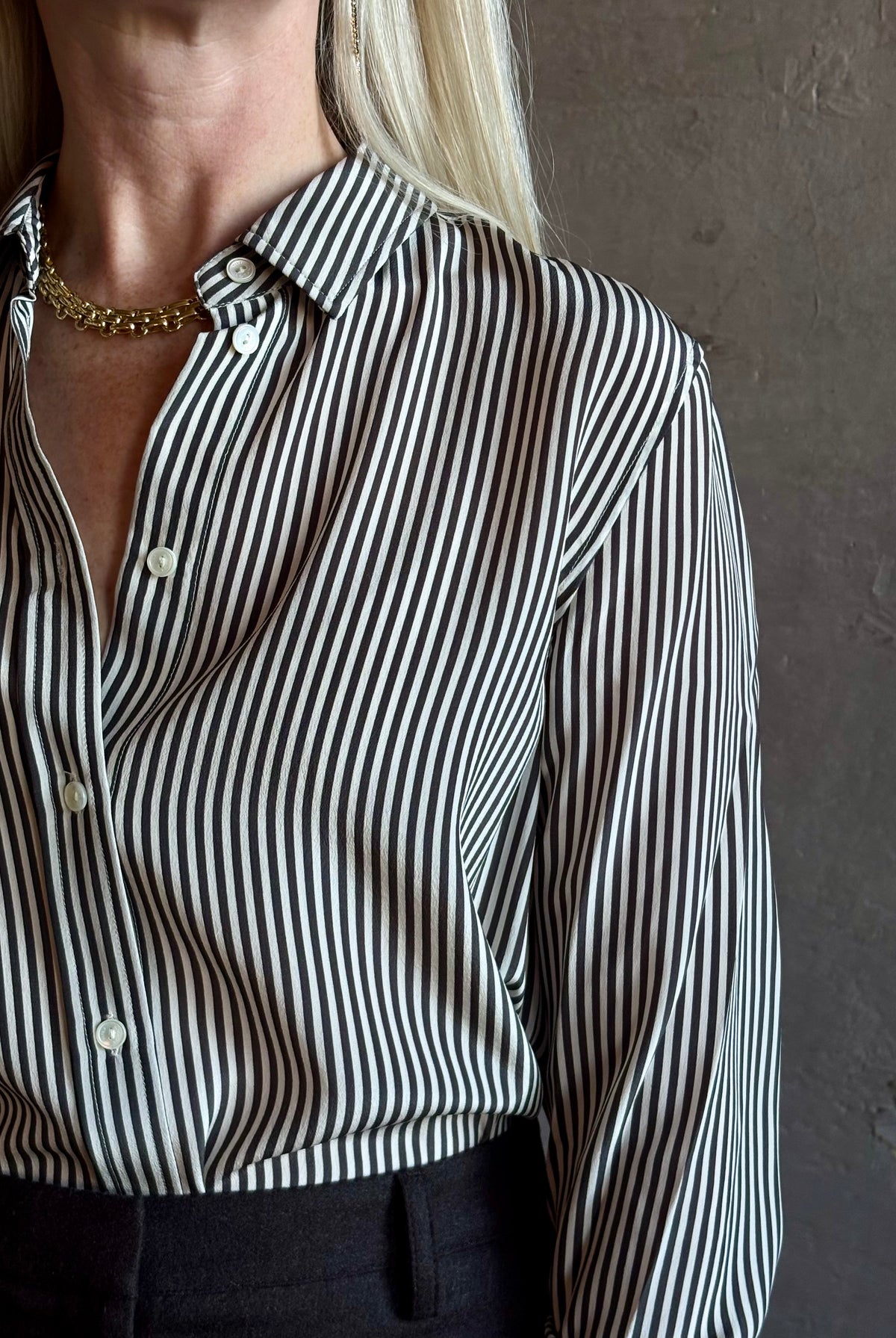 Mature woman wearing Nili Lotan Gaia Slim Silk Shirt in Dark Brown/Cream Stripe classic button front Made in the USA