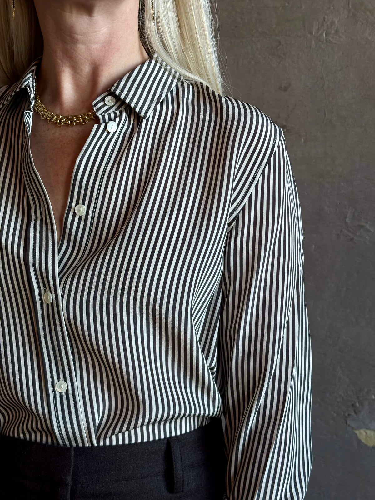 Mature woman wearing Nili Lotan Gaia Slim Silk Shirt in Dark Brown/Cream Stripe classic button front Made in the USA
