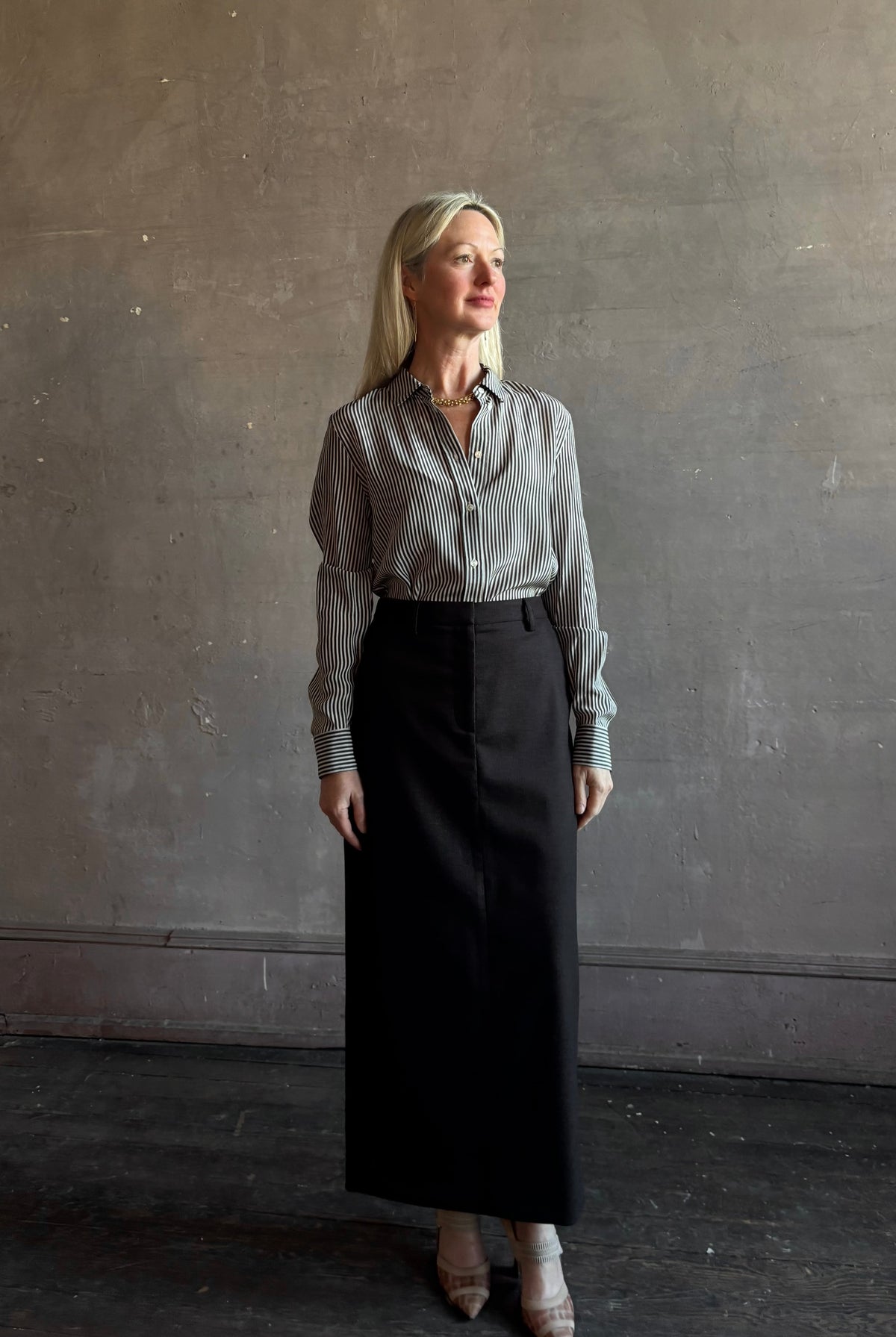 Mature woman wearing Nili Lotan Gaia Slim Silk Shirt in Dark Brown/Cream Stripe tailored long sleeve bouse Made in the USA
