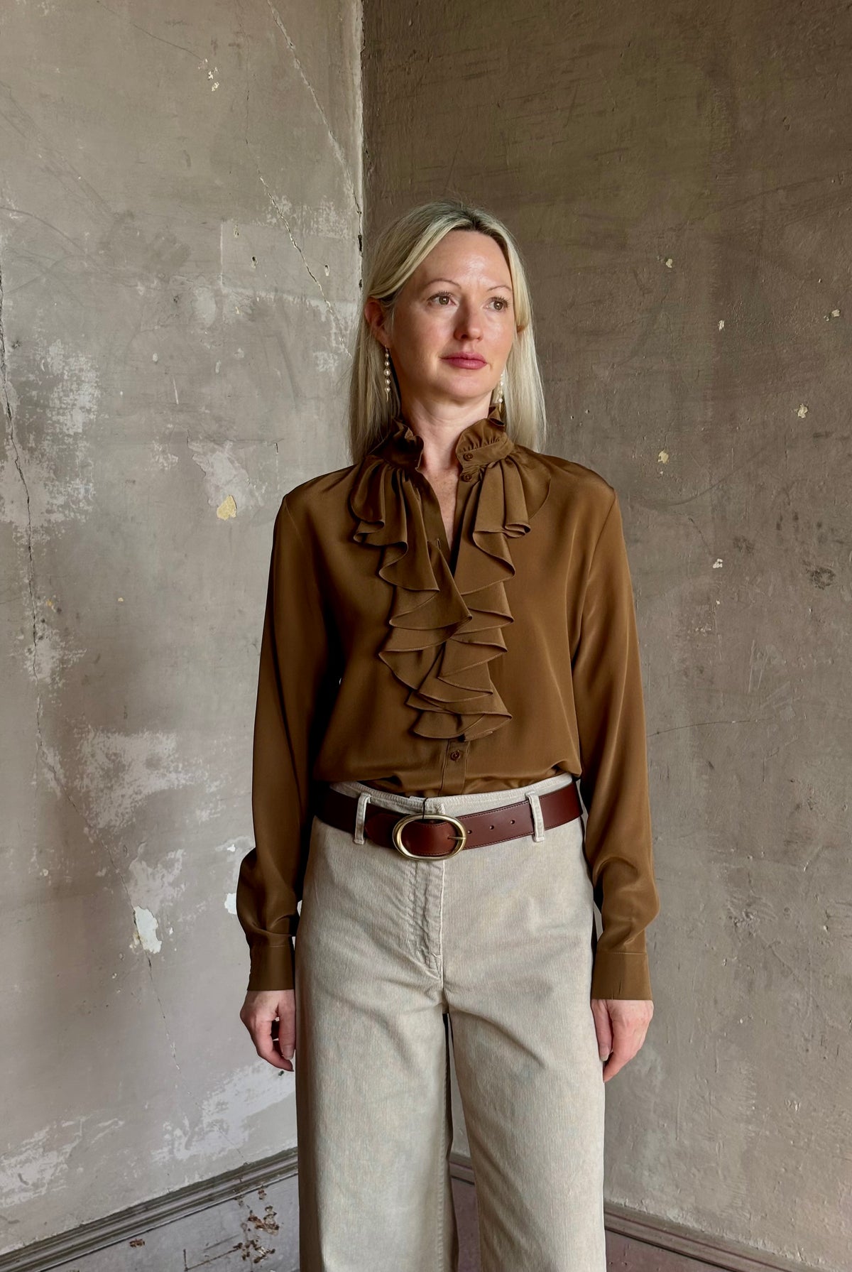 Mature woman wearing Nili Lotan's Lily Long sleeve Blouse Cognac silk delicate front ruffle Warm romantic American-made