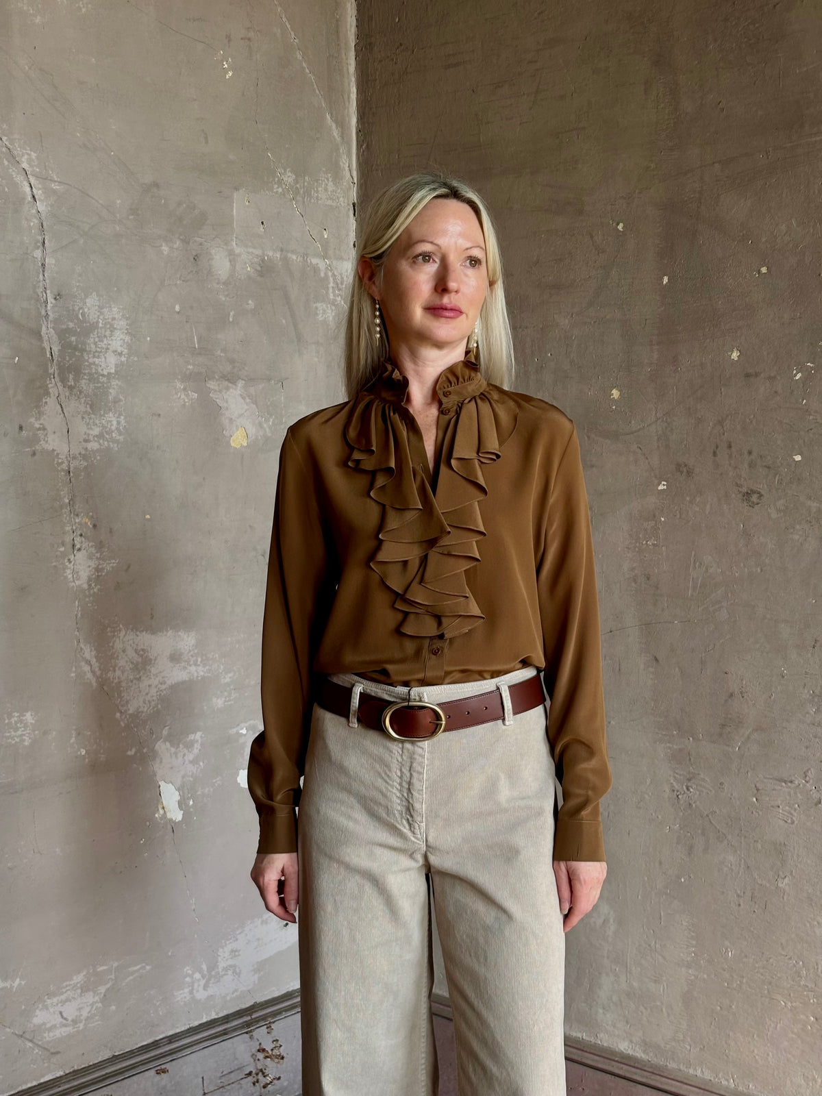 Mature woman wearing Nili Lotan's Lily Long sleeve Blouse Cognac silk delicate front ruffle Warm romantic American-made