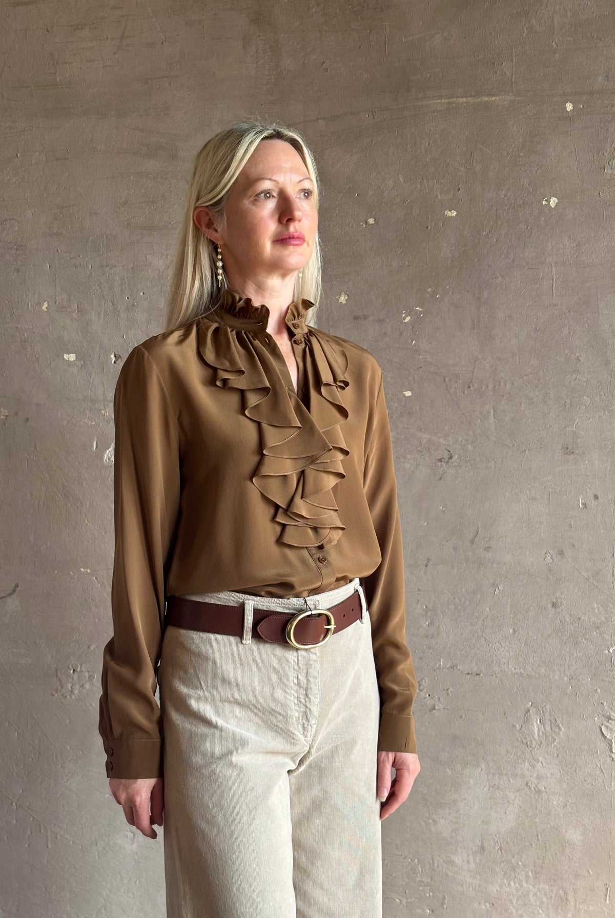 Mature woman wearing Nili Lotan's Lily Long sleeve Blouse Cognac silk delicate front ruffle Warm romantic American-made