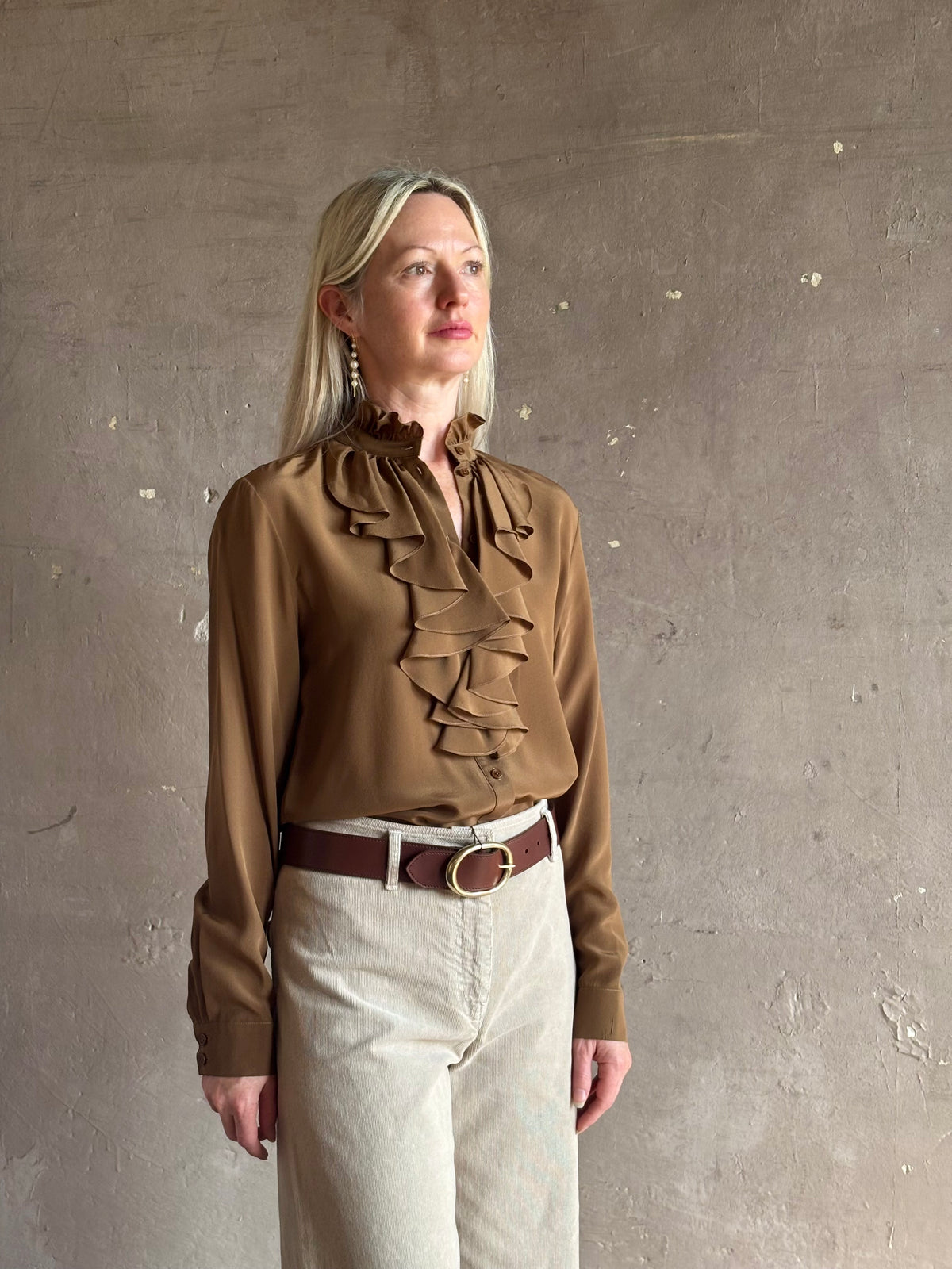 Mature woman wearing Nili Lotan's Lily Long sleeve Blouse Cognac silk delicate front ruffle Warm romantic American-made