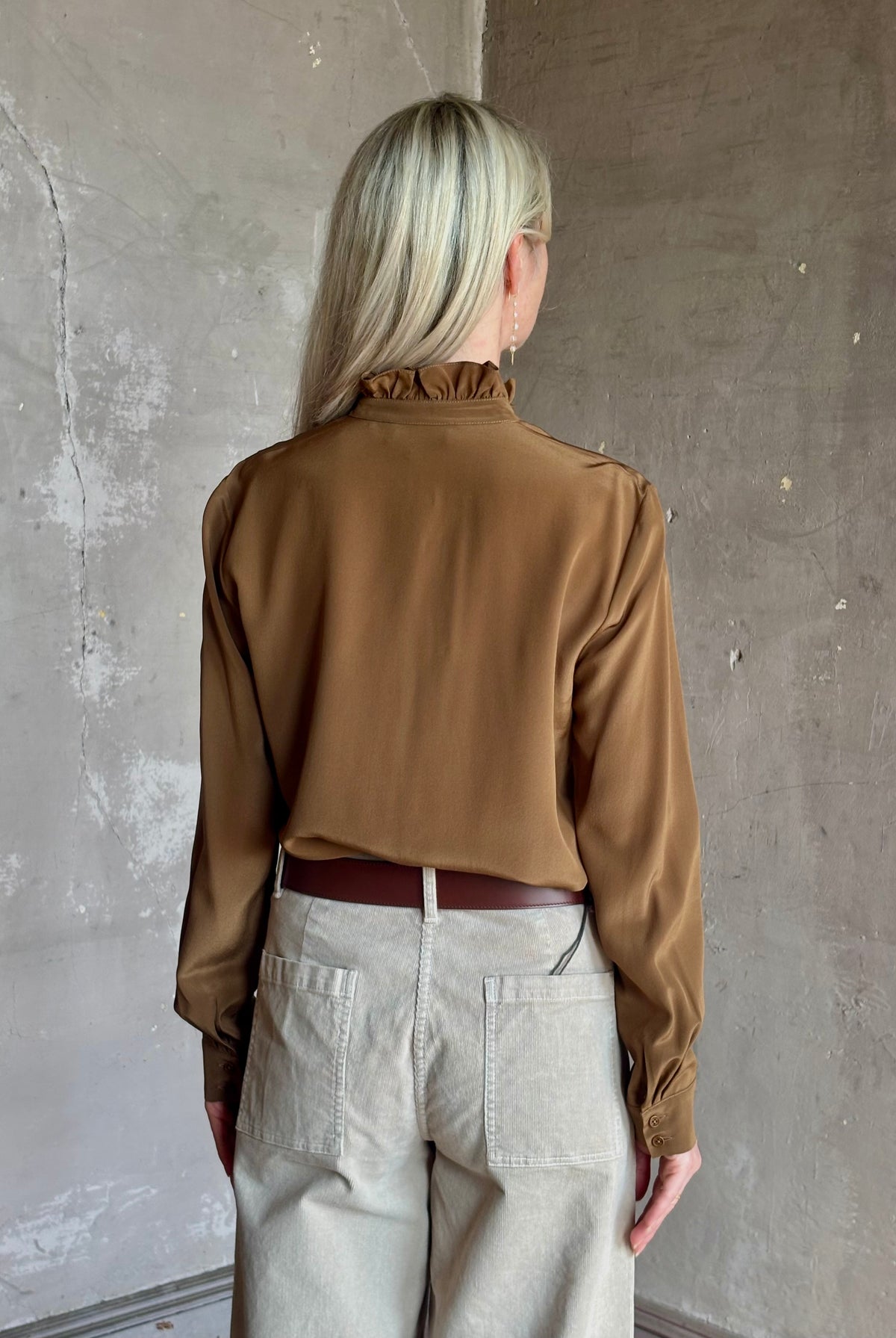 Mature woman wearing Nili Lotan's Lily Long sleeve Blouse Cognac silk delicate front ruffle Warm romantic American-made