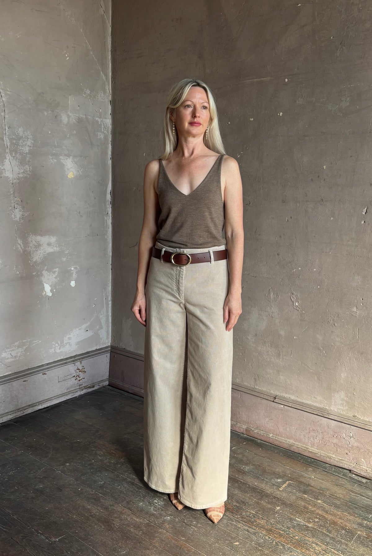 Mature woman wearing Nili Lotan flat front straight leg megan pant in beige corduroy mid rise machine washable cotton