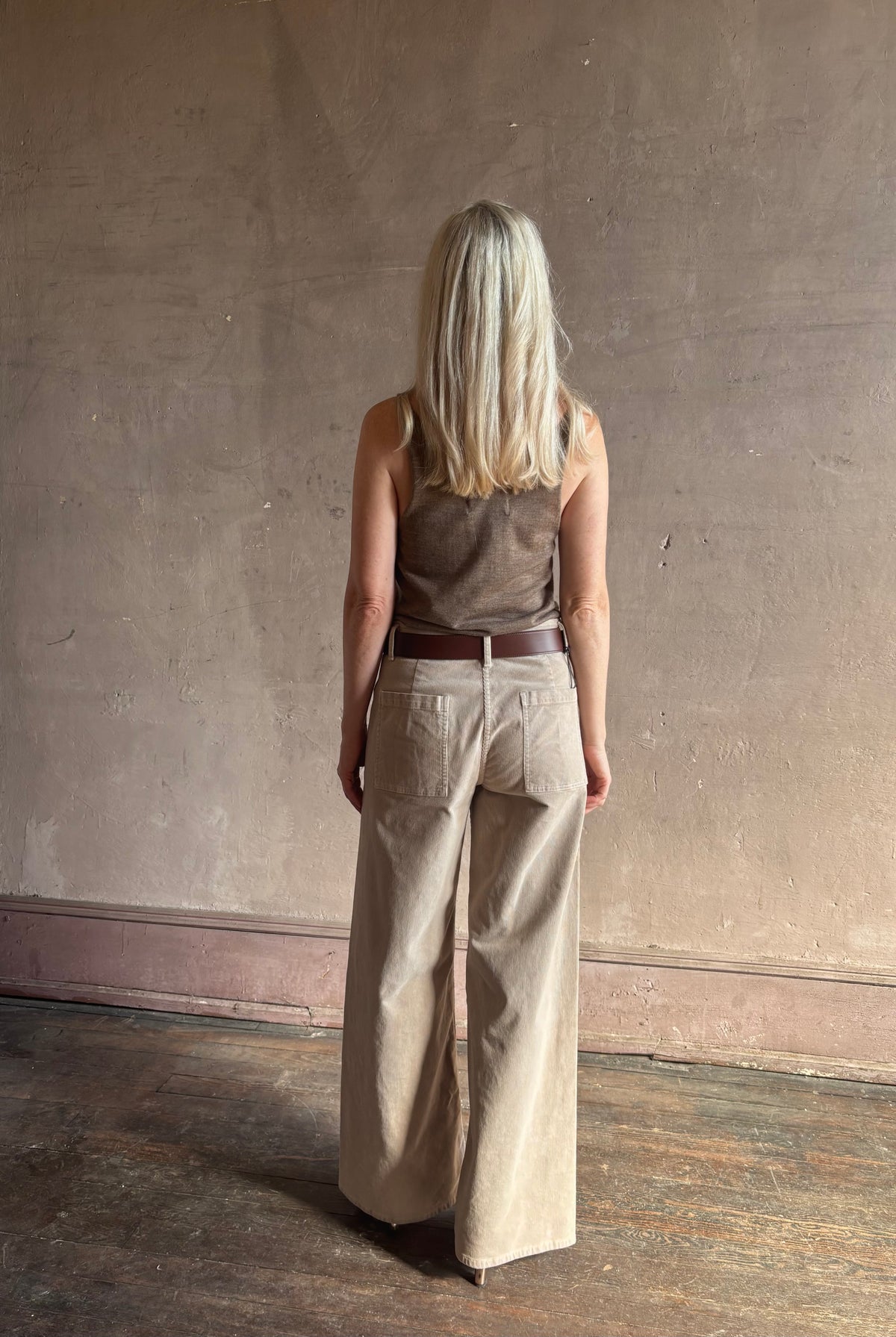 Mature woman wearing Nili Lotan flat front straight leg megan pant in beige corduroy mid rise machine washable cotton