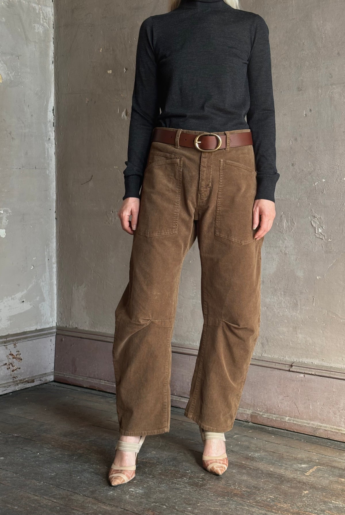 Mature woman wearing Nili Lotan Shon brown barrel-leg corduroy pants front pockets natural fiber made in USA