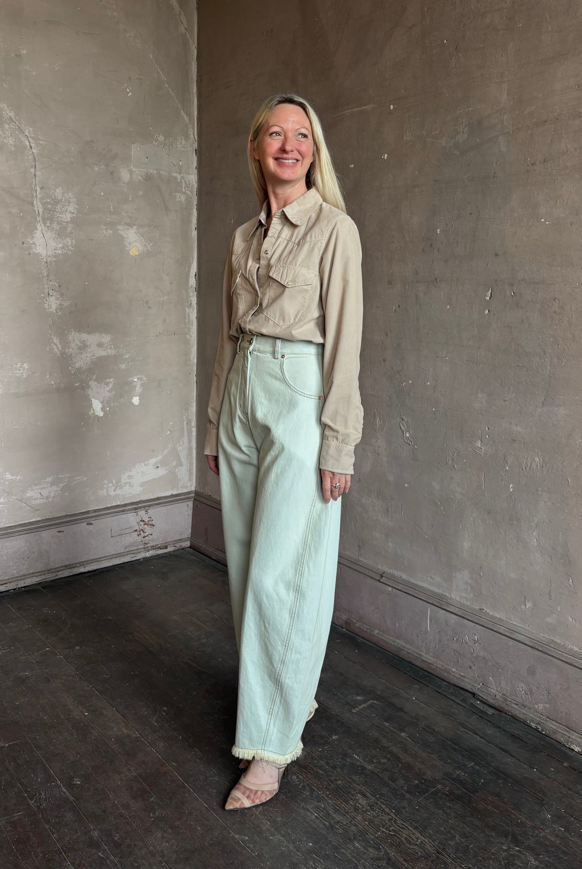 Mature woman wearing Nili Lotan's Travis Corduroy Shirt in Travertine cotton corduroy Western-inspired snap buttons