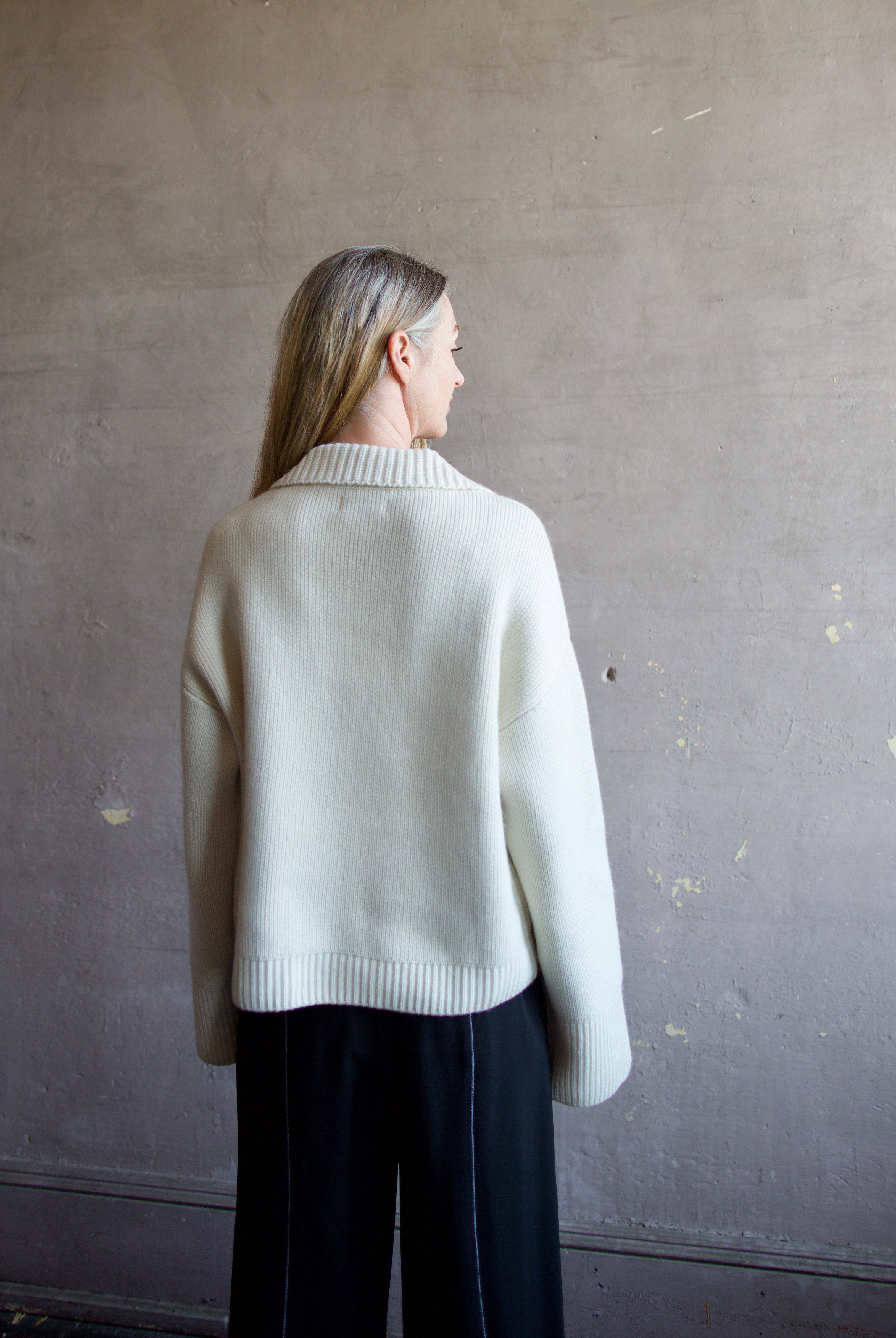 Image featuring a woman wearing this Ultra Luxe Cashmere Polo Sweater by Naadam in cream with a split neckline and collar in an oversized fit.