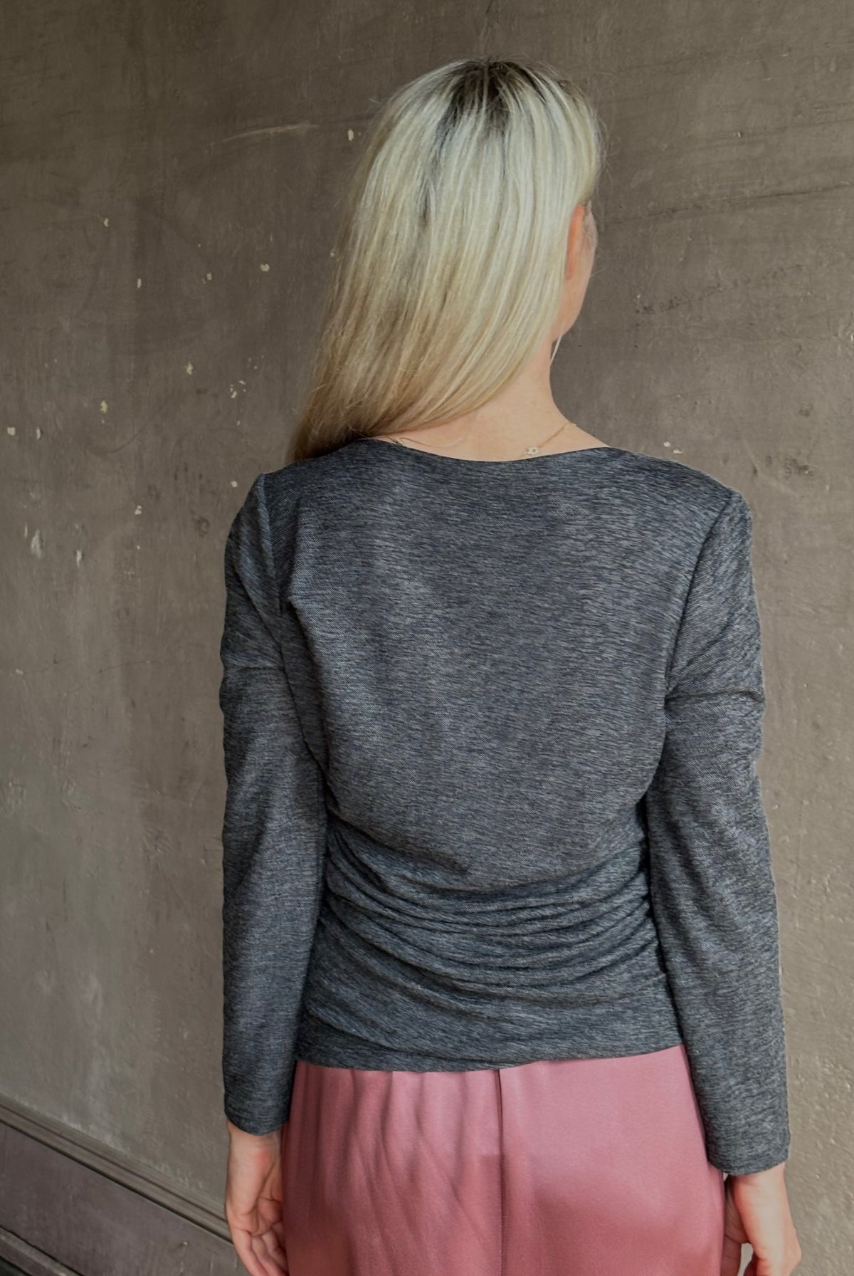 Woman wearing Proenza Schouler Blythe charcoal Top reversable long sleeves wool side ruching luxe draping