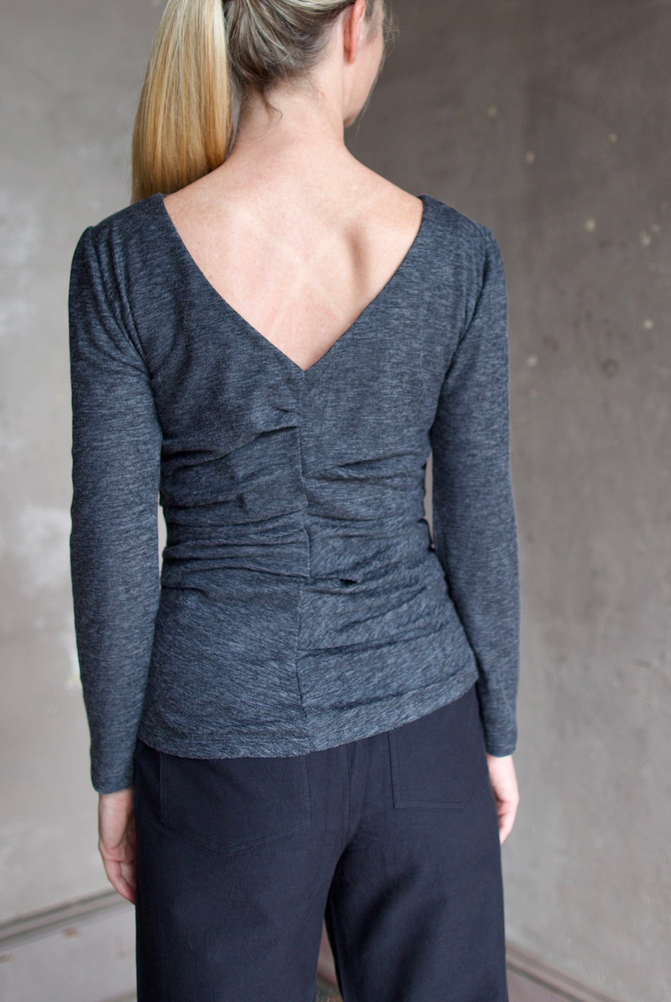 Model wearing Proenza Schouler Blythe Top in charcoal. Top can be reversed front or back offering two different looks.