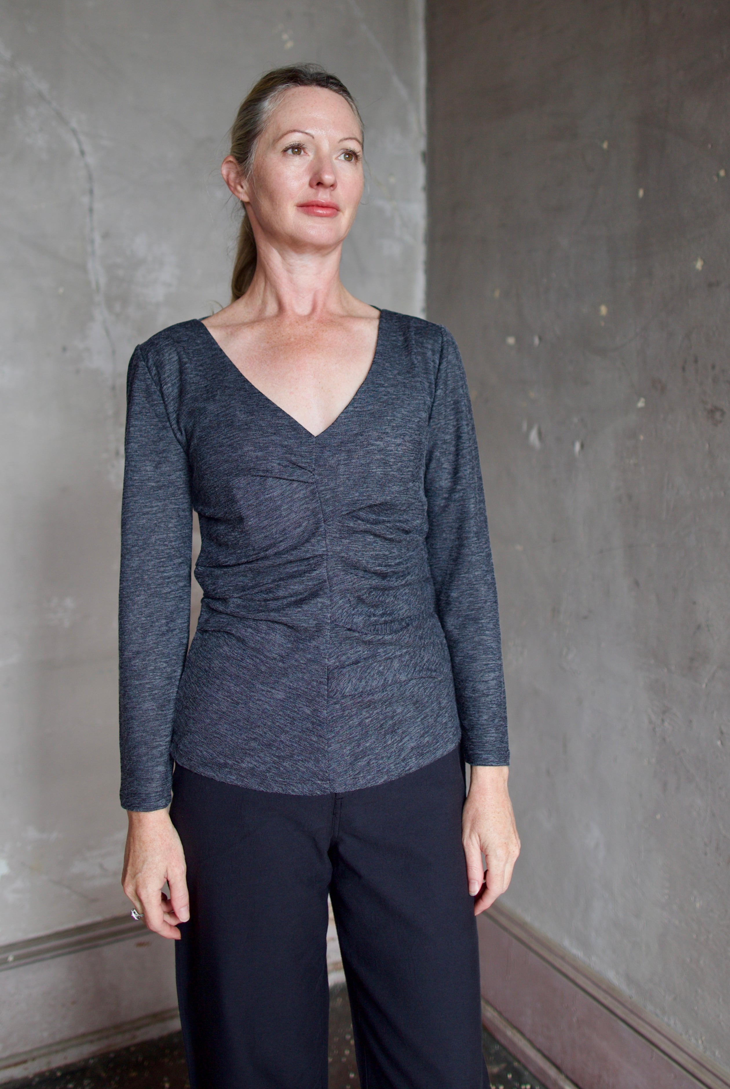 Model wearing Proenza Schouler Blythe Top in charcoal. Top can be reversed front or back offering two different looks.