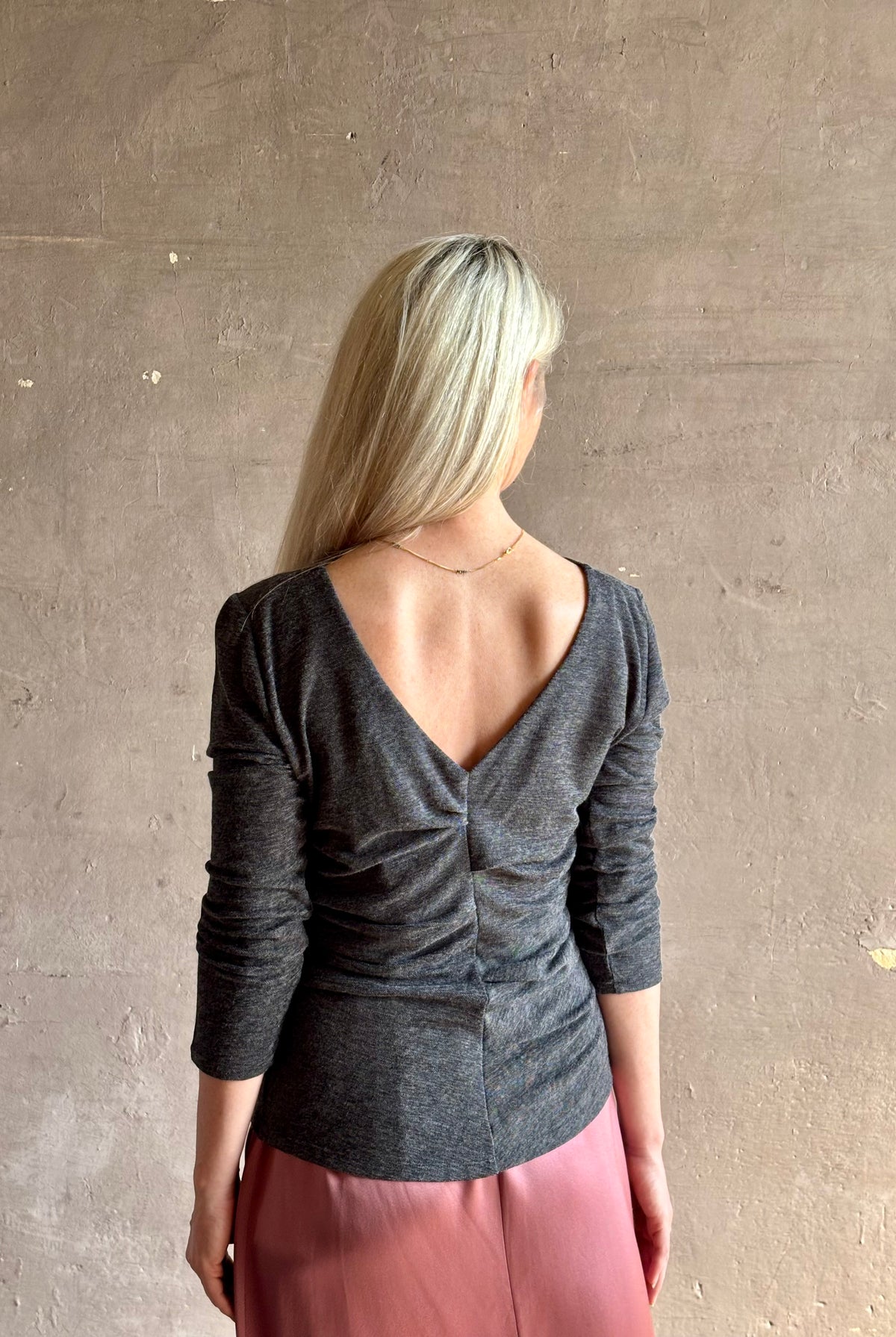 Woman wearing Proenza Schouler Blythe charcoal Top reversable long sleeves wool side ruching luxe draping