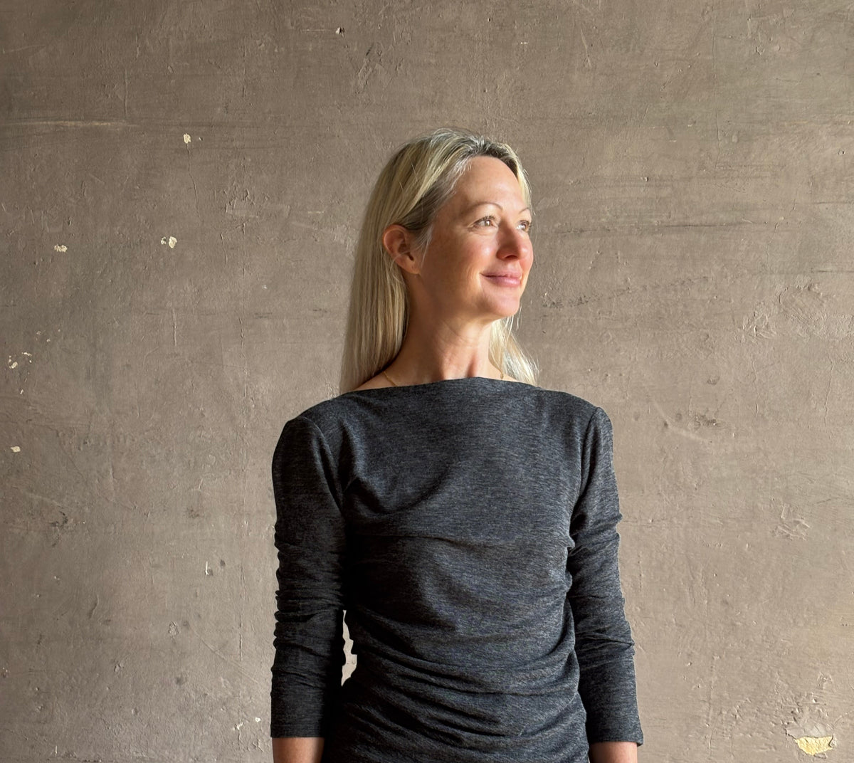 Woman wearing Proenza Schouler Blythe charcoal Top reversable long sleeves wool side ruching luxe draping