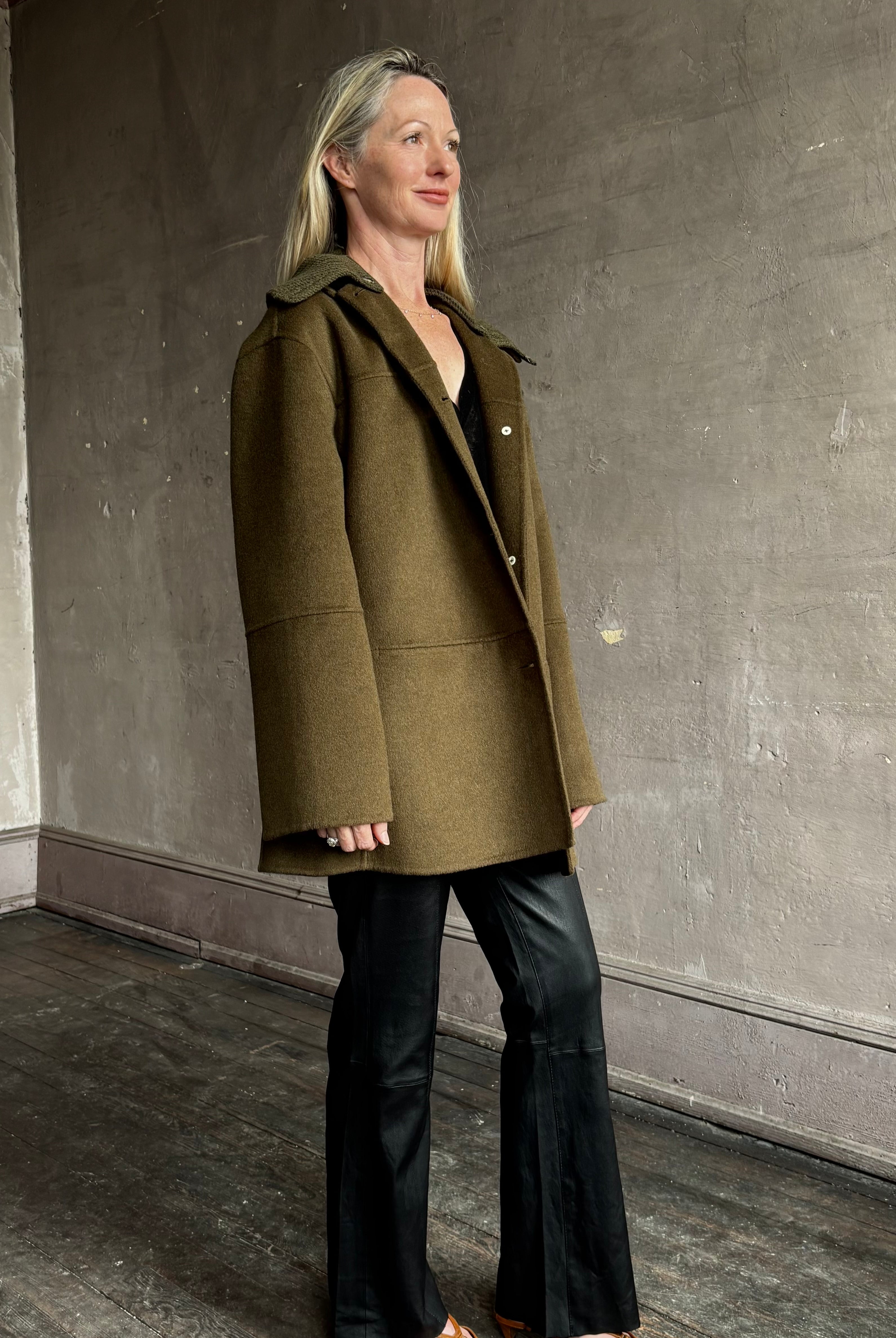Image of woman wearing luxury brand Proenza Schoulder double faced green wool coat with detachable collar and classic back detailing