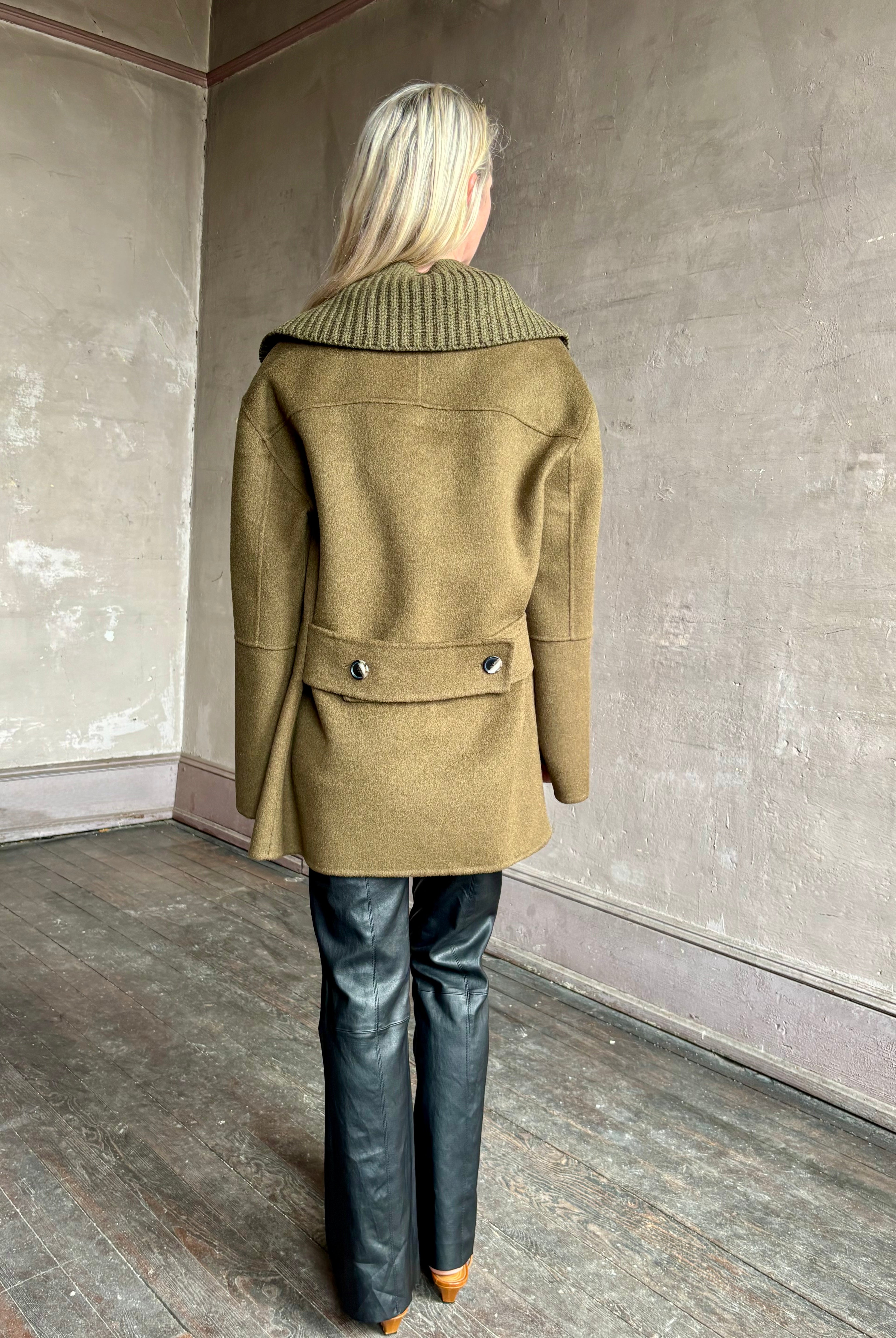 Image of woman wearing luxury brand Proenza Schoulder double faced wool coat with detachable collar and classic back detailing