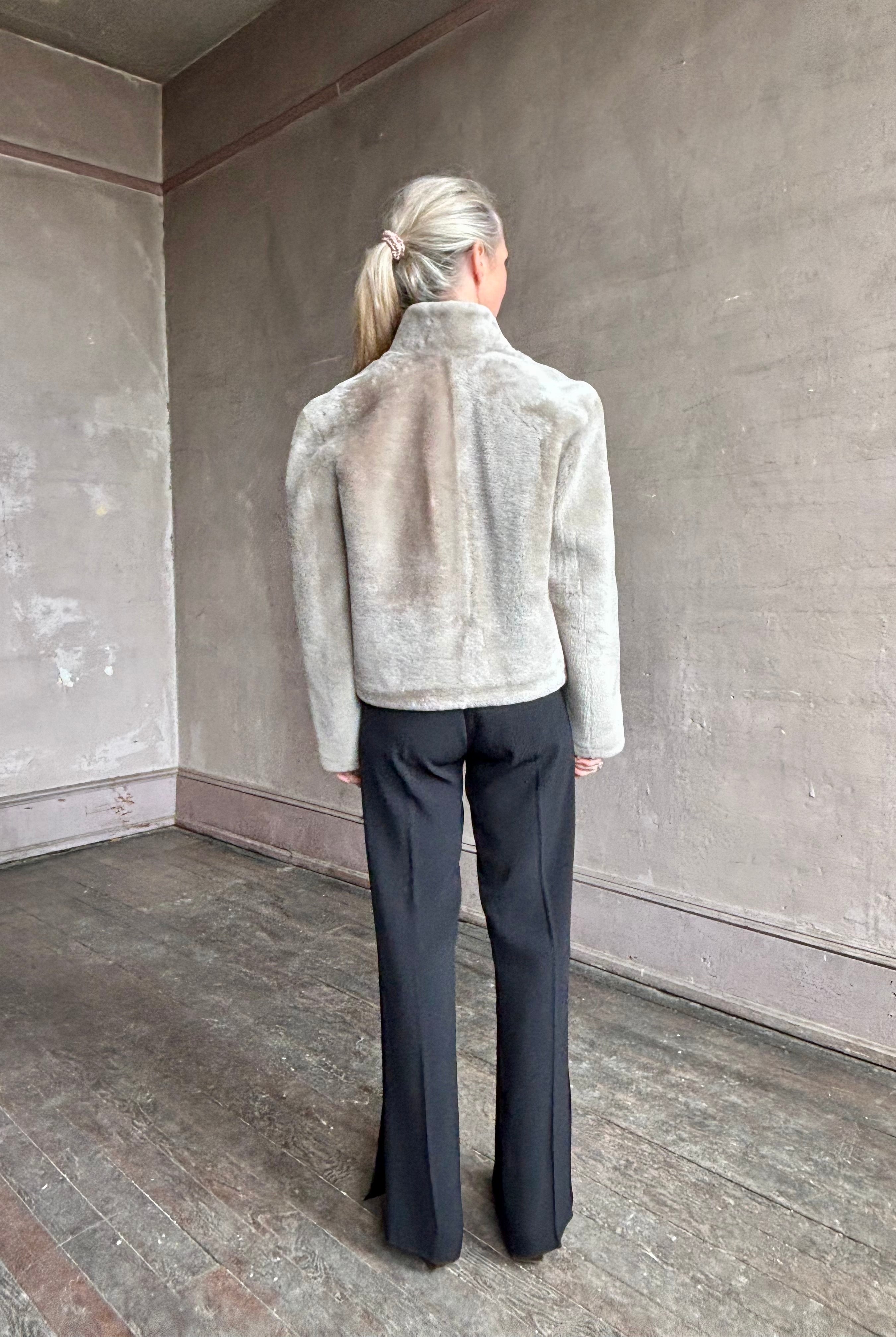 Image of a mature woman wearing Proenza Schouler Scarlett shearling jacket with a zip front and pockets in the perfect mid hip length