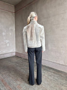 Image of a mature woman wearing Proenza Schouler Scarlett shearling jacket with a zip front and pockets in the perfect mid hip length