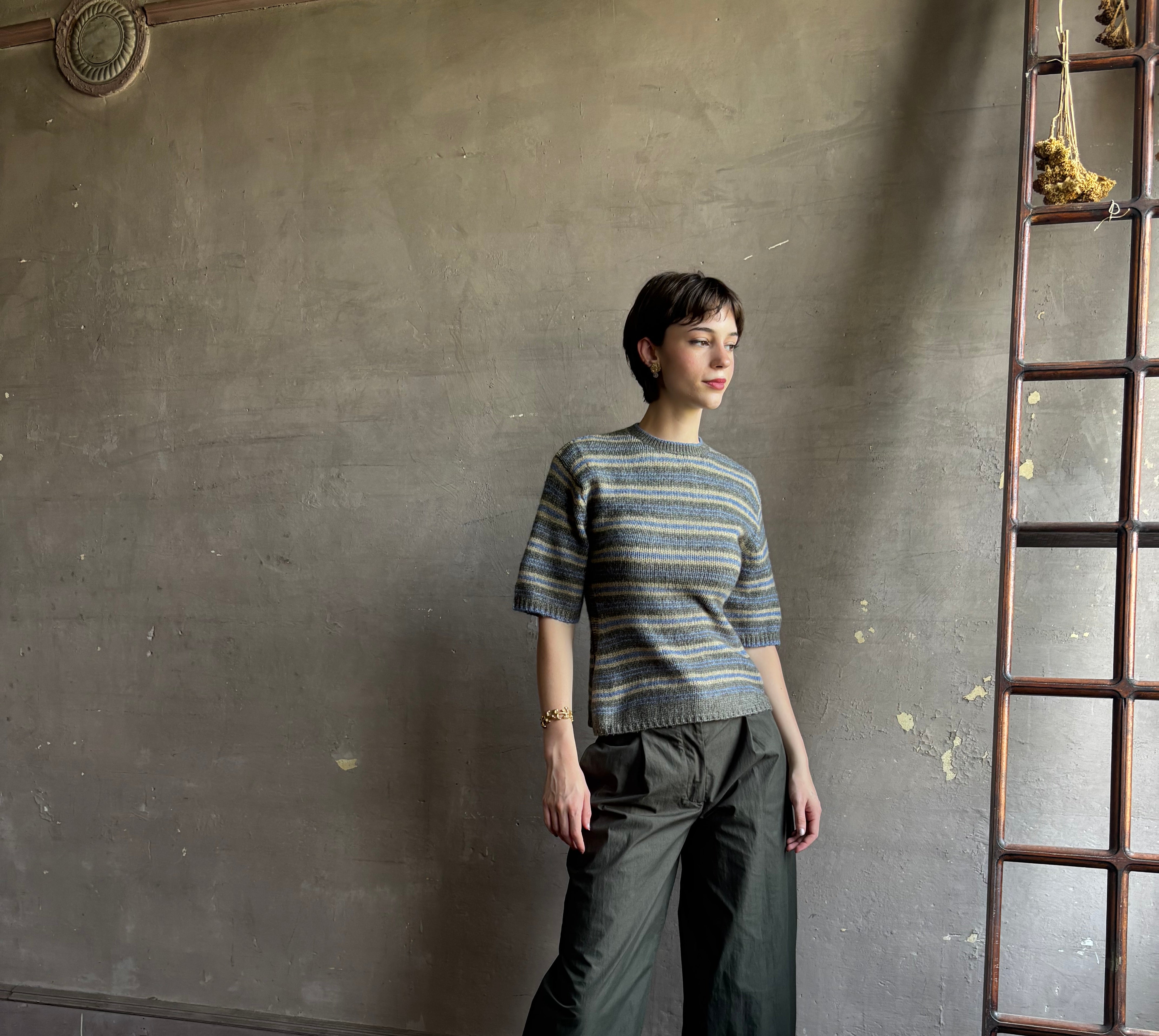 woman wearing Proenza Schoulder Dana sweater with short-sleeve knit top with blue, gray, and beige horizontal stripes